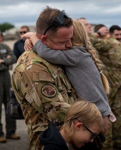 An Airman hugs his child