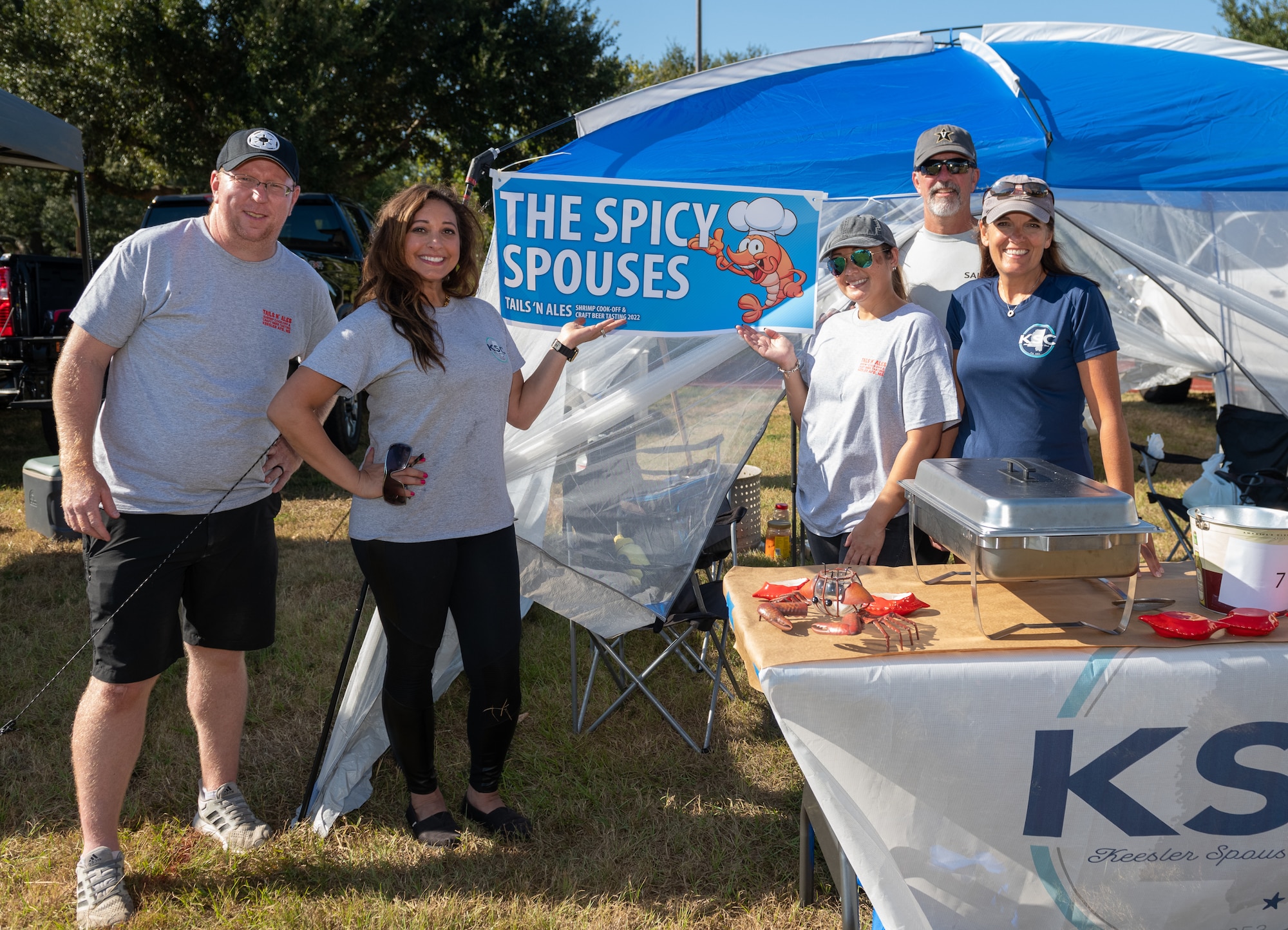 Members of the "Spicy Spouses" team pose for a photo during the Tails 'N Ales Annual Shrimp Cook-off outside the Bay Breeze Event Center at Keesler Air Force Base, Mississippi, Oct. 14, 2022. The 81st Force Support Squadron hosted event offered a variety of craft beers for tasting and many teams fighting for the ultimate best shrimp recipe. (U.S. Air Force photo by Andre' Askew)