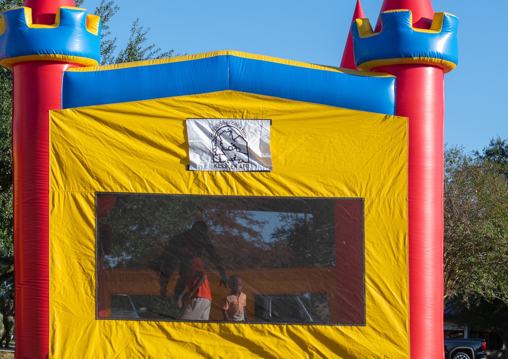 Keesler children play in a bounce house during the Tails 'N Ales Annual Shrimp Cook-off outside the Bay Breeze Event Center at Keesler Air Force Base, Mississippi, Oct. 14, 2022. The 81st Force Support Squadron hosted event offered a variety of craft beers for tasting and many teams fighting for the ultimate best shrimp recipe. (U.S. Air Force photo by Andre' Askew)