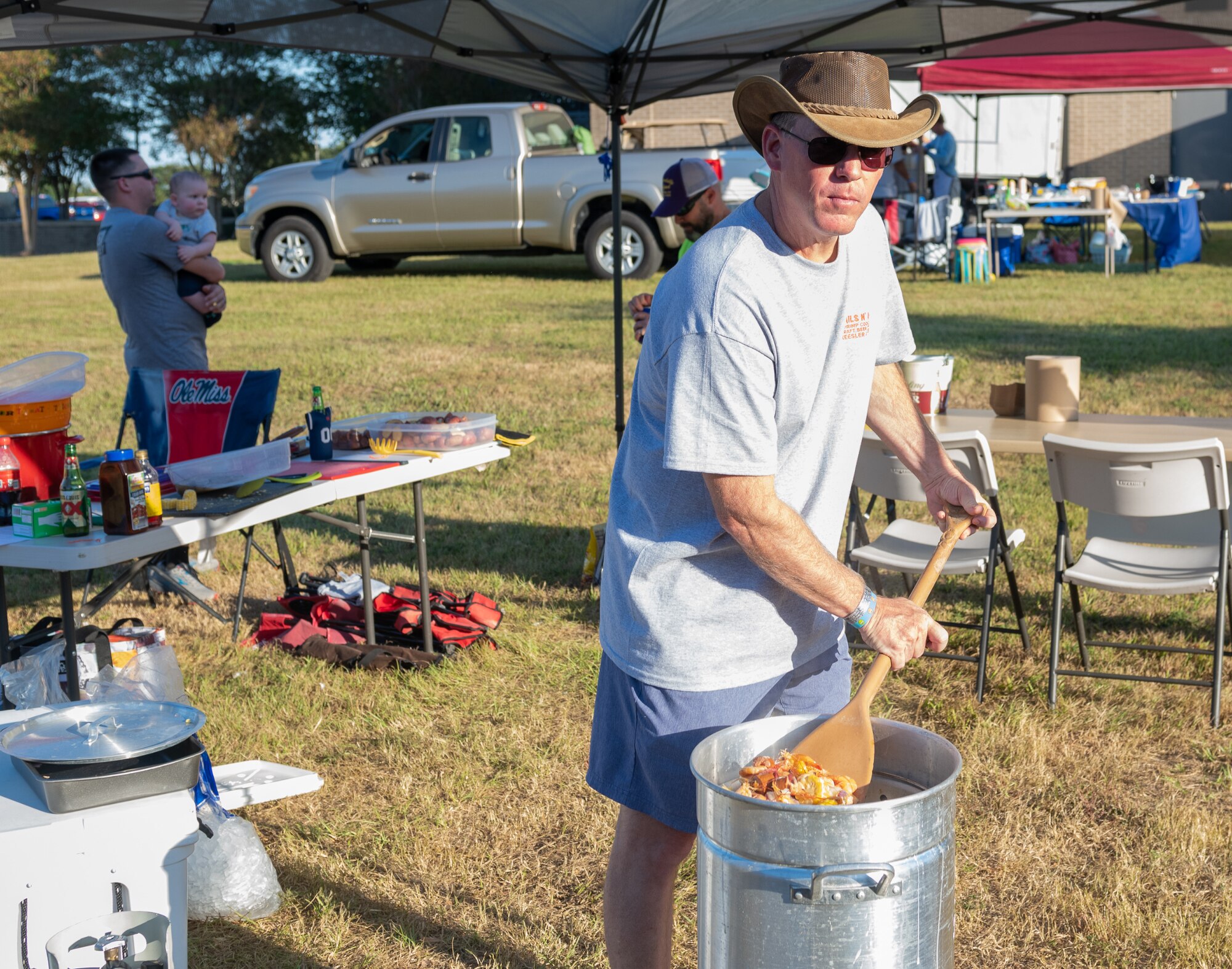 U.S. Air Force Col. C. Mike Smith, Second Air Force A3/6 commander and "Shucking to None" team member, stirs a pot of boiled shrimp during the Tails ’N Ales Annual Shrimp Cook-off outside the Bay Breeze Event Center at Keesler Air Force Base, Mississippi, Oct. 14, 2022. The 81st Force Support Squadron hosted event offered a variety of craft beers for tasting and many teams fighting for the ultimate best shrimp recipe. (U.S. Air Force photo by Andre' Askew)