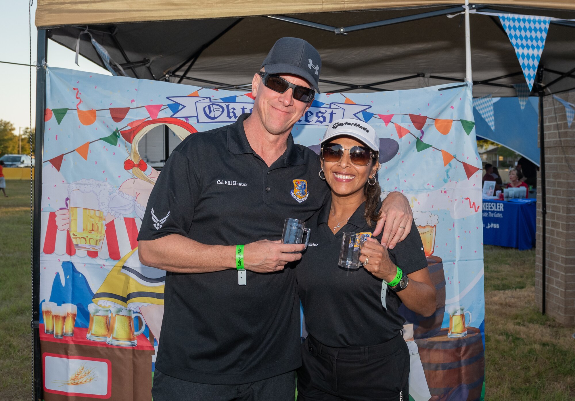 U.S. Air Force Col. William Hunter, 81st Training Wing commander, and his wife, Blanca, pose for a photo during the Tails 'N Ales Annual Shrimp Cook-off outside the Bay Breeze Event Center at Keesler Air Force Base, Mississippi, Oct. 14, 2022. The 81st Force Support Squadron hosted event offered a variety of craft beers for tasting and many teams fighting for the ultimate best shrimp recipe. (U.S. Air Force photo by Andre' Askew)