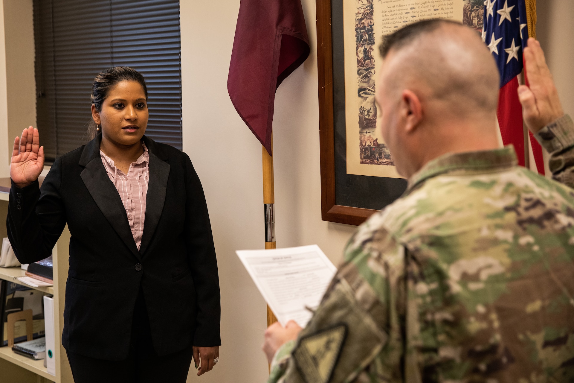 Army Capt. Sara Powell takes the oath of commissioned officers from Chief Warrant Officer Tim Collins at the Boone National Guard Center in Frankfort, Ky. on Oct. 18, 2022. Powell is the medical facility director at St. Joseph Hospital in Mt. Sterling, Ky. and has commissioned to be the 149th Maneuver Enhancement Brigade surgeon. (U.S. Army photo by Andy Dickson)