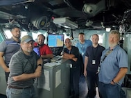 A team of engineers from Naval Surface Warfare Center, Philadelphia Division from the Program Executive Office Integrated Warfare Systems (PEO IWS) Team perform critical testing and evaluation of the software upgrades to the Wasp-class amphibious assault ship USS Kearsarge (LHD 3). The team is responsible for developing and testing the Navy - Electronic Chart Display and Information System (Navy ECDIS) software upgrades.



Starting from left to right – Shawn Anderson (NSWCPD), Michael Morton (NSWCPD), Larry Bjonnes (NSWCPD), Benito Martinez (NSWCPD), Michael Luniewski (Northrup Grumman), Brandon Wood (NSWCPD), Ruben Holstrom (NIWC Atlantic). (U.S. Navy Photo by Shawn Anderson/Released. Portions of this image were blurred for security reasons)