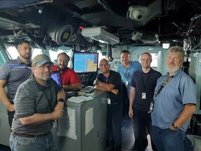 A team of engineers from Naval Surface Warfare Center, Philadelphia Division from the Program Executive Office Integrated Warfare Systems (PEO IWS) Team perform critical testing and evaluation of the software upgrades to the Wasp-class amphibious assault ship USS Kearsarge (LHD 3). The team is responsible for developing and testing the Navy - Electronic Chart Display and Information System (Navy ECDIS) software upgrades.



Starting from left to right – Shawn Anderson (NSWCPD), Michael Morton (NSWCPD), Larry Bjonnes (NSWCPD), Benito Martinez (NSWCPD), Michael Luniewski (Northrup Grumman), Brandon Wood (NSWCPD), Ruben Holstrom (NIWC Atlantic). (U.S. Navy Photo by Shawn Anderson/Released. Portions of this image were blurred for security reasons)