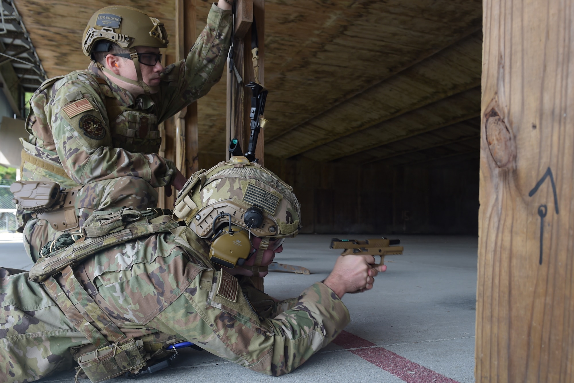 two men shooting a pistol
