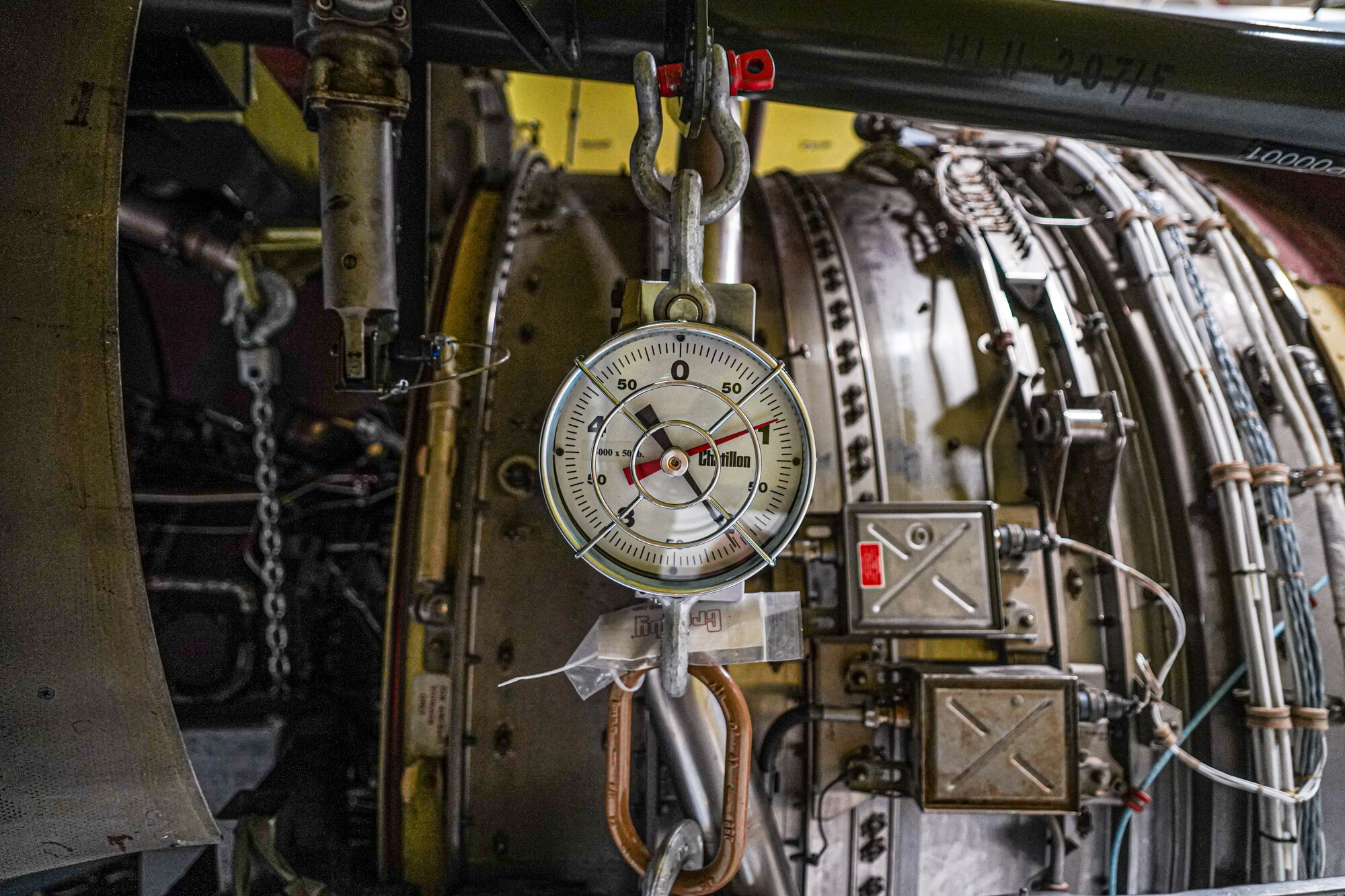 A weight scale is attached to a KC-135 Stratotanker engine that's assigned to the 914th Air Refueling Wing at Niagara Falls Air Reserve Station, New York, before being lifted into its engine compartment on Oct. 18, 2022. (U.S. Air Force photo by 1st Lt. Lucas Morrow)