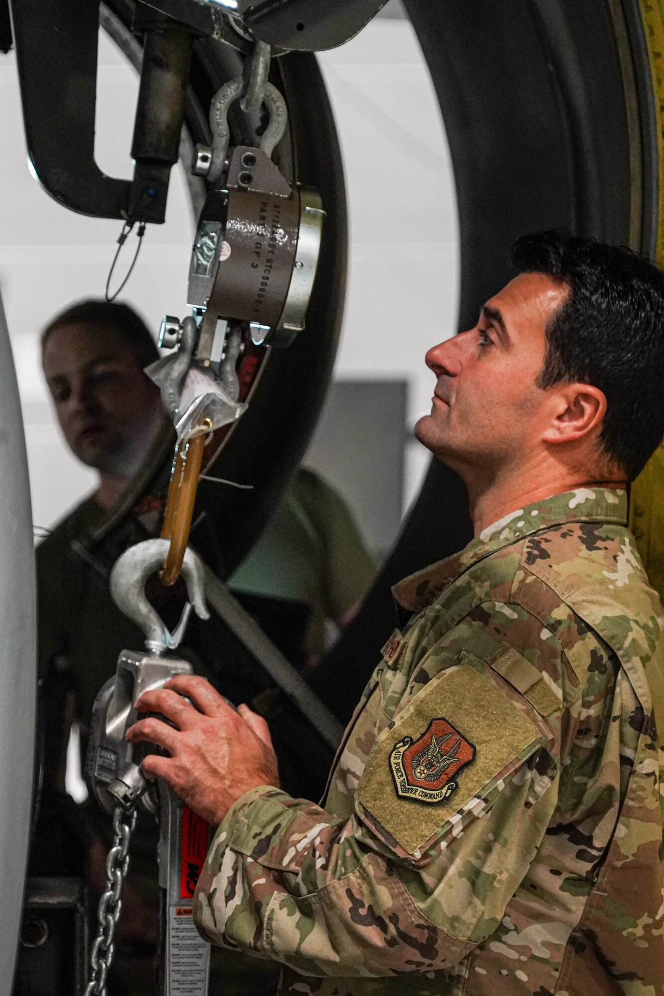 Tech. Sgt. Thomas Carozzolo, an aerospace propulsion specialist assigned to the 914th Aircraft Maintenance Squadron at Niagara Falls Air Reserve Station, New York, carefully watches a weight gauge attached to a KC-135 Stratotanker engine on Oct. 18, 2022. While lifting the engine into place, its weight must be carefully distributed across the engine to ensure it's properly installed. (U.S. Air Force photo by 1st Lt. Lucas Morrow)