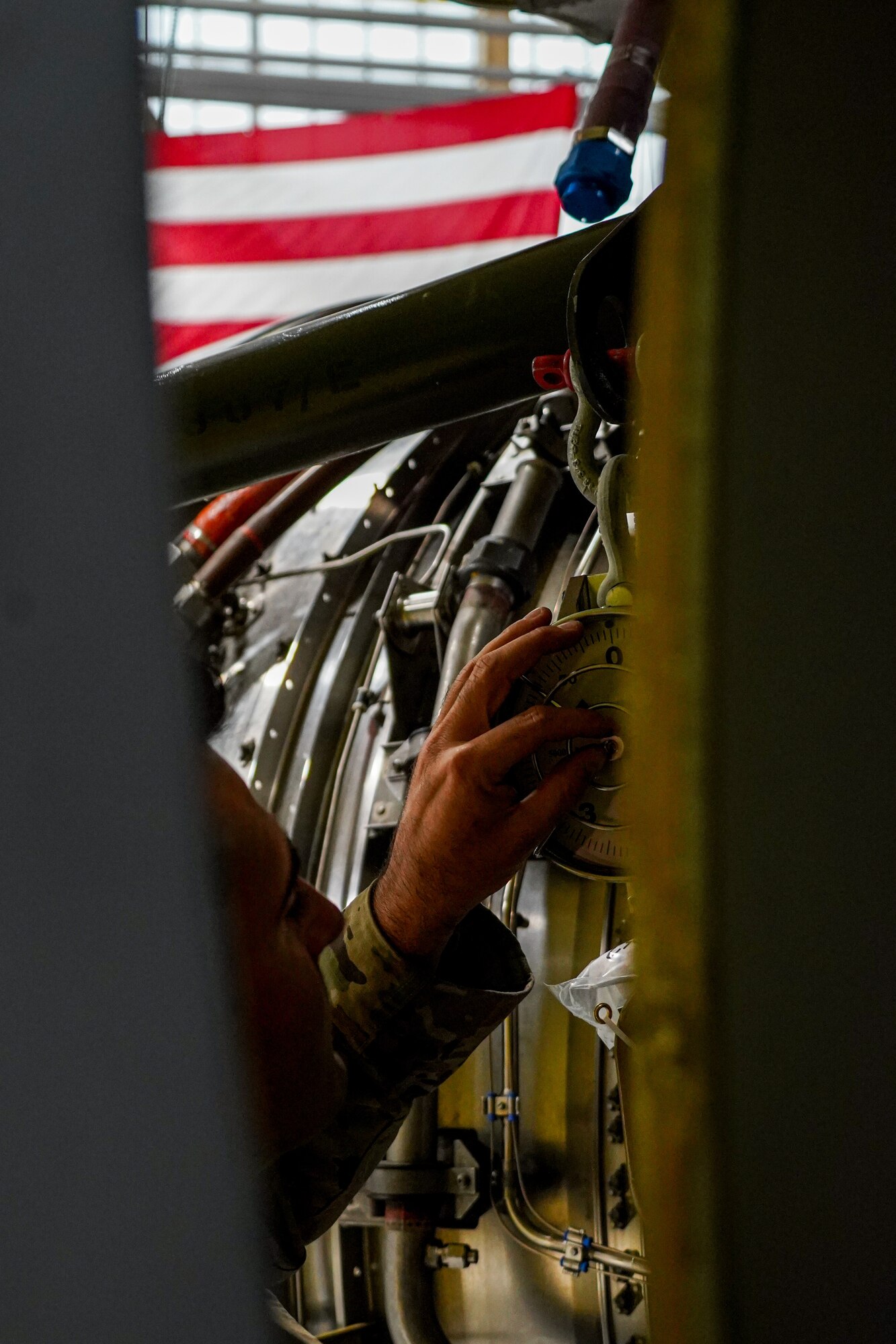 Tech. Sgt. Thomas Carozzolo, an aerospace propulsion specialist assigned to the 914th Aircraft Maintenance Squadron at Niagara Falls Air Reserve Station, New York, carefully inspects a weight gauge attached to a KC-135 Stratotanker engine on Oct. 18, 2022. The engine's weight must be carefully distributed across the engine while it's being jacked into place to properly install it onto the Stratotanker. (U.S. Air Force photo by 1st Lt. Lucas Morrow)