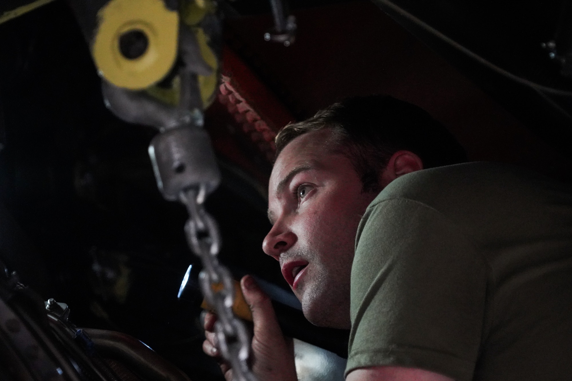 Tech. Sgt. Alexander Brown, an aerospace propulsion specialist assigned to the 914th Aircraft Maintenance Squadron at Niagara Falls Air Reserve Station, New York, inspects the alignment of a KC-135 Stratotanker engine mounting bracket during an engine lift on Oct. 18, 2022. (U.S. Air Force photo by 1st Lt. Lucas Morrow)