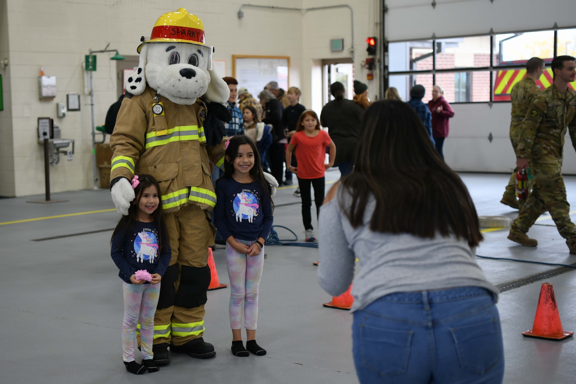 Sparky the Fire Dog and children pose for a photo during the 319th Civil Engineer Squadron fire department open house Oct. 15, 2022, at Grand Forks Air Force Base, North Dakota. The 2022 Fire Prevention Week’s campaign was, “Fire won’t wait. Plan your escape.” Members of the fire department worked to educate the community about simple but important actions they can take to keep themselves and those around them safe from home fires.
 (U.S. Air Force Photo by Senior Airman Ashley Richards)