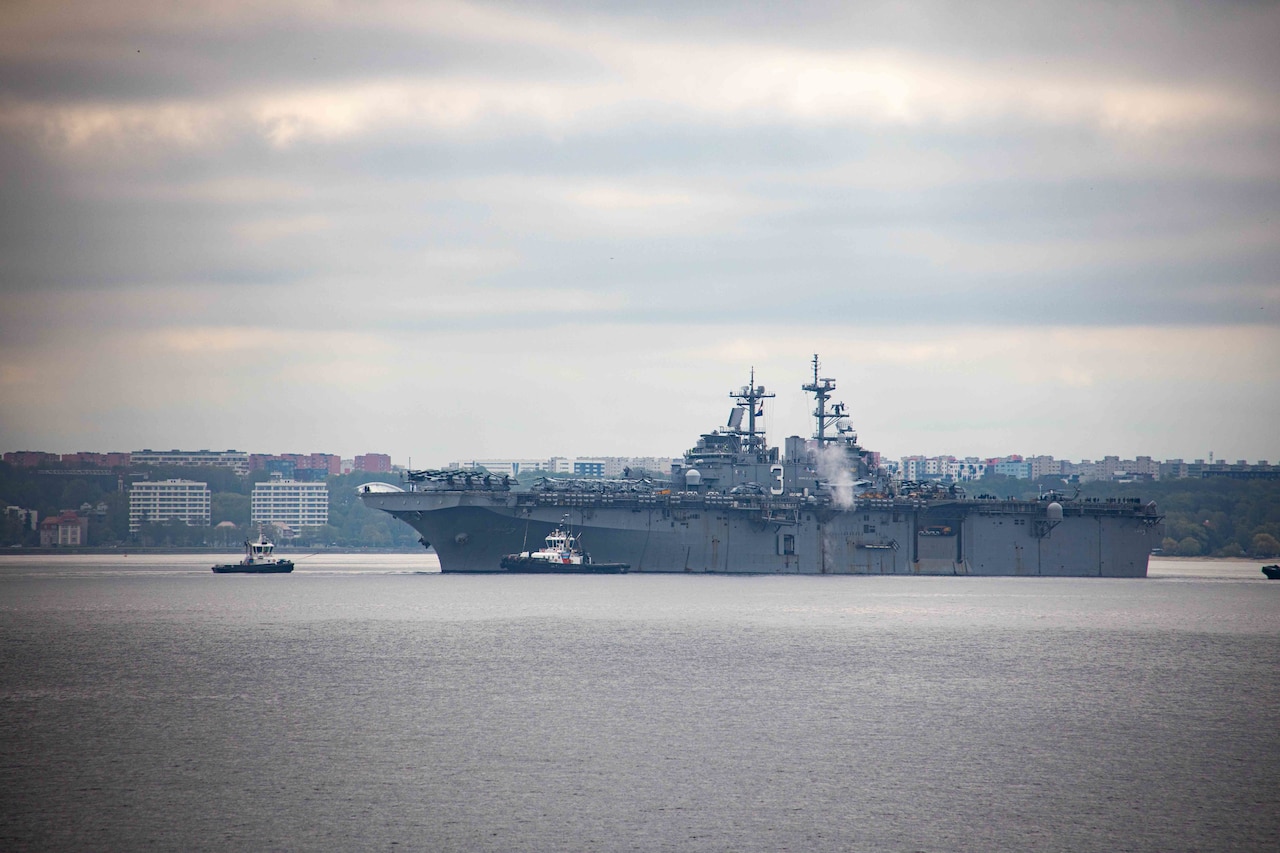 A large ship pulls into a harbor.