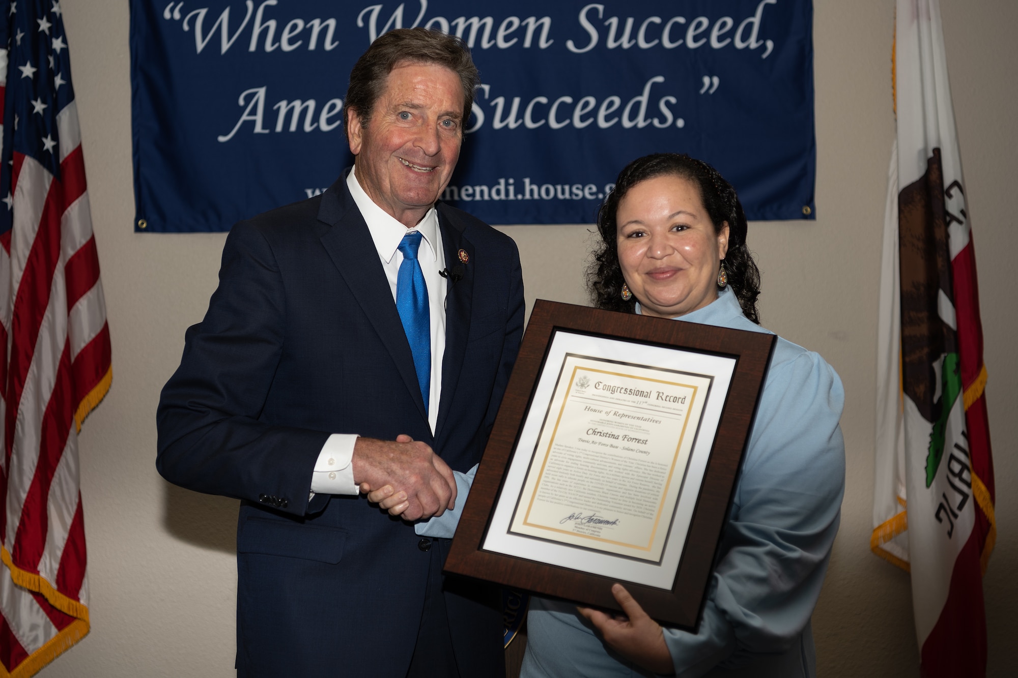 Congressman gives award to a woman honoree