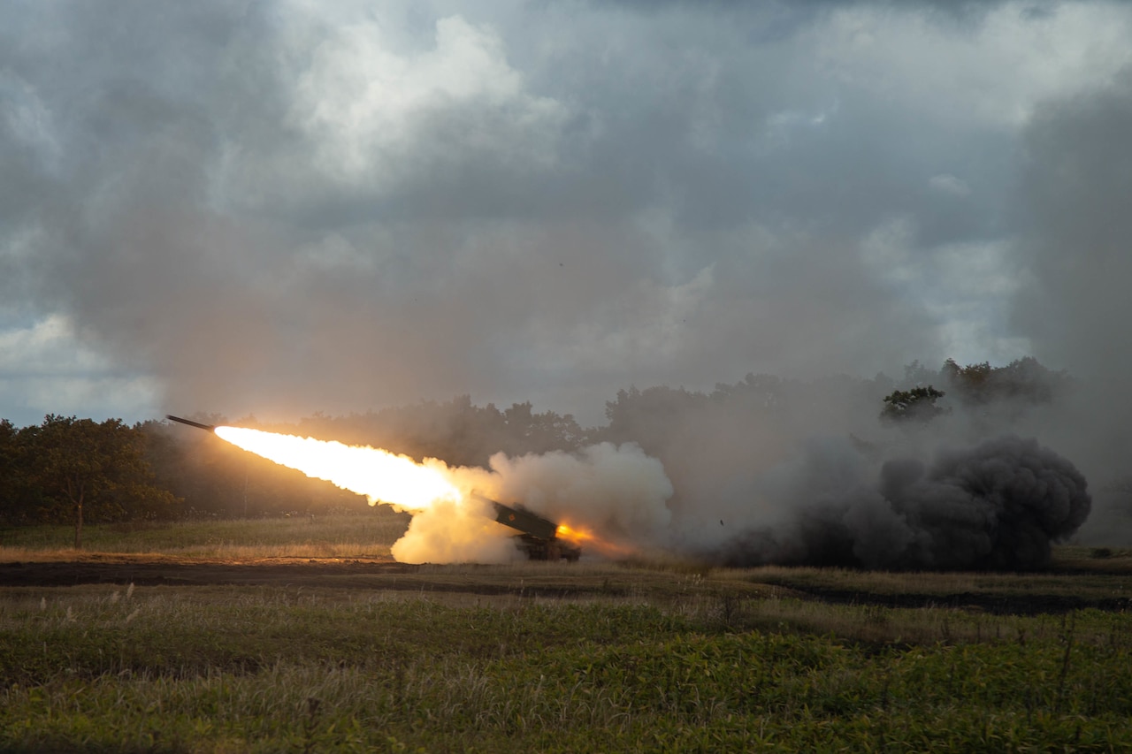 A rocket launches. It is trailed by fire and smoke.