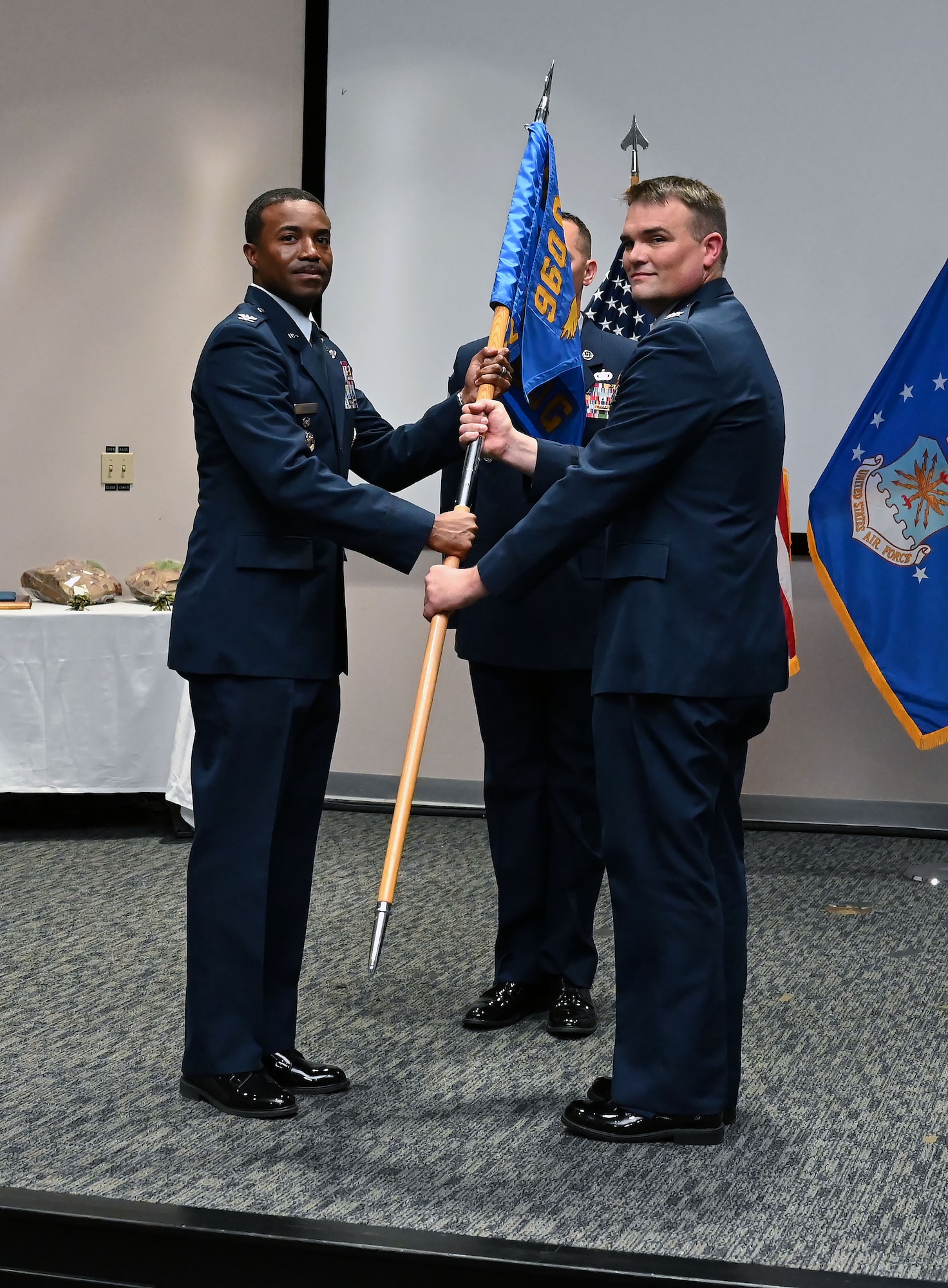 Col. Silas Darden, 960th Cyberspace Wing vice commander, presents the leadership guidon to Col. Richard Wallace, 960th COG commander, during the 960th COG change of command ceremony at Joint Base San Antonio-Lackland, Texas, Oct. 15, 2022. Wallace was the Individual Mobilization Augmentee to the 567th Cyberspace Operations Group commander at JBSA-Lackland. (U.S. Air Force photo by Staff Sgt. Monet Villacorte)