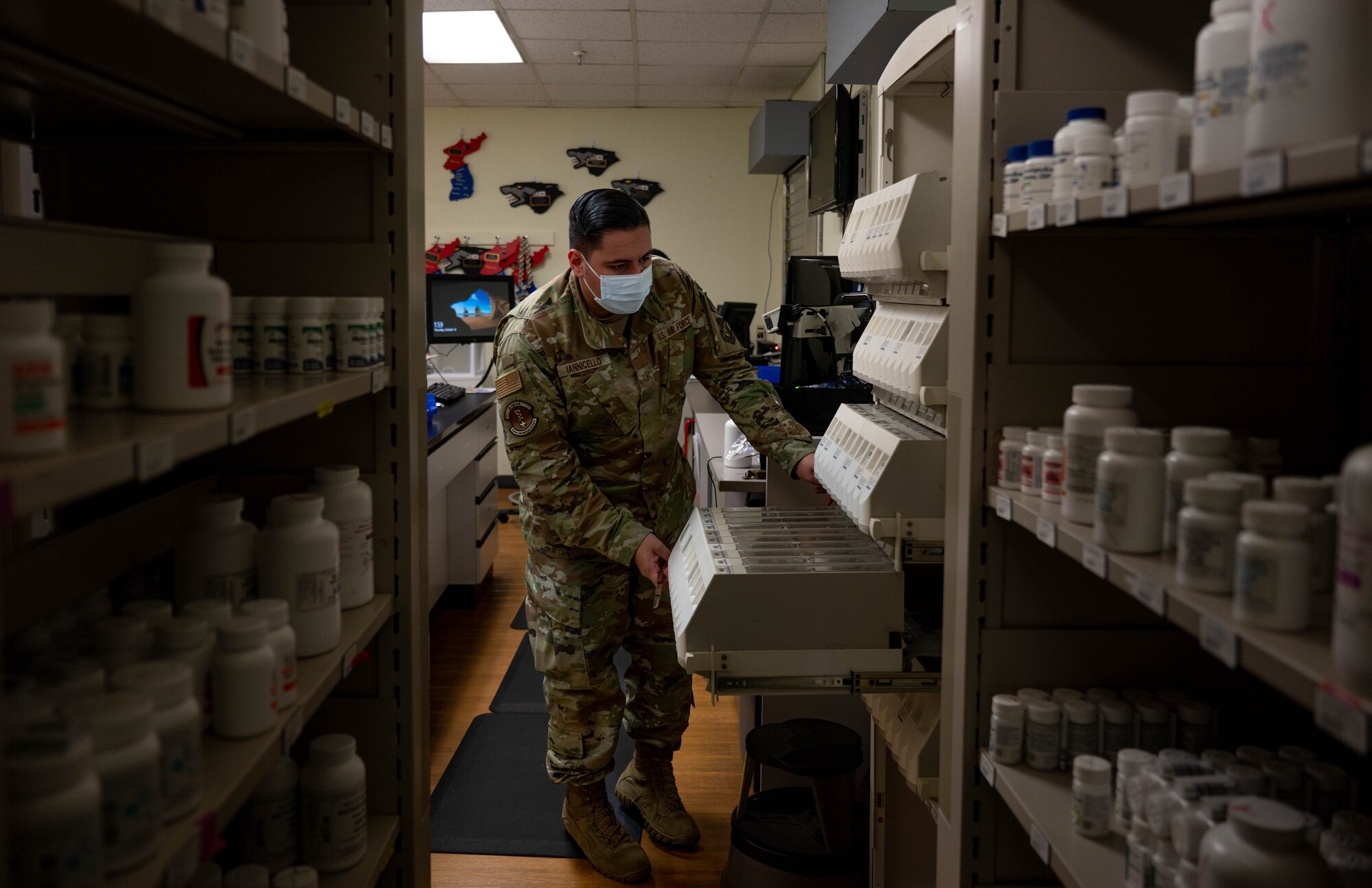 Tech. Sgt. Anthony Iannicello, 8th Healthcare Operations Squadron, pharmacy NCO in charge, opens a secure medicine container, at Kunsan Air Base, Republic of Korea, Oct. 13, 2022. In addition to filling medication, the pharmacy also supports walk-in treatment for acute issues expedited by a pharmacist after a brief visit, smoking cessation and assisting Airmen with translating and filling prescriptions from off-base providers.  (U.S. Air Force Photo by Senior Airman Shannon Braaten)