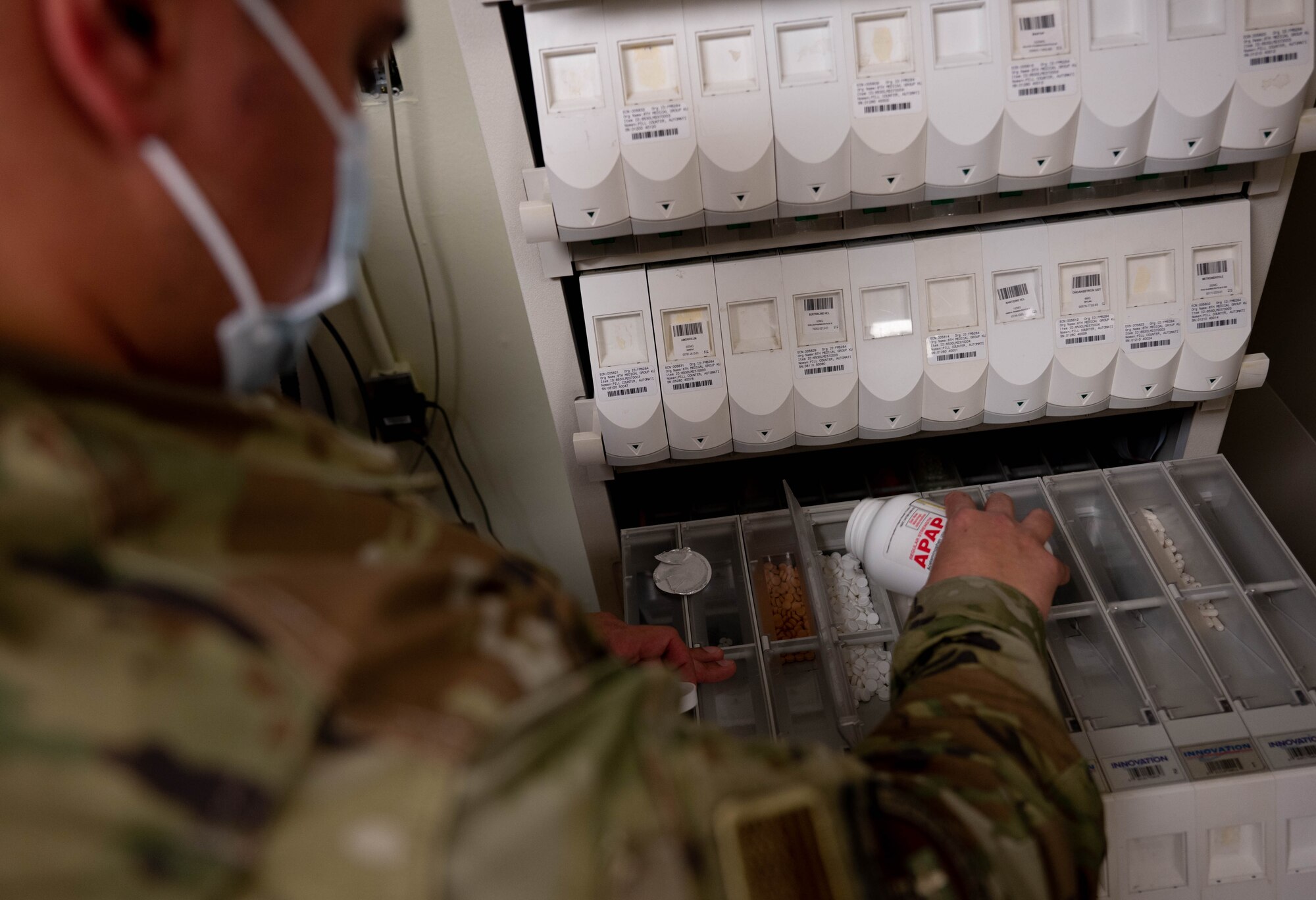 Tech. Sgt. Anthony Iannicello, 8th Healthcare Operations Squadron, pharmacy NCO in charge, pours pills into a secure storage container, at Kunsan Air Base, Republic of Korea, Oct. 13, 2022. Before dispensing medication, pharmacy team members review the prescription orders to ensure the medication and dosage are correct. (U.S. Air Force Photo by Senior Airman Shannon Braaten)