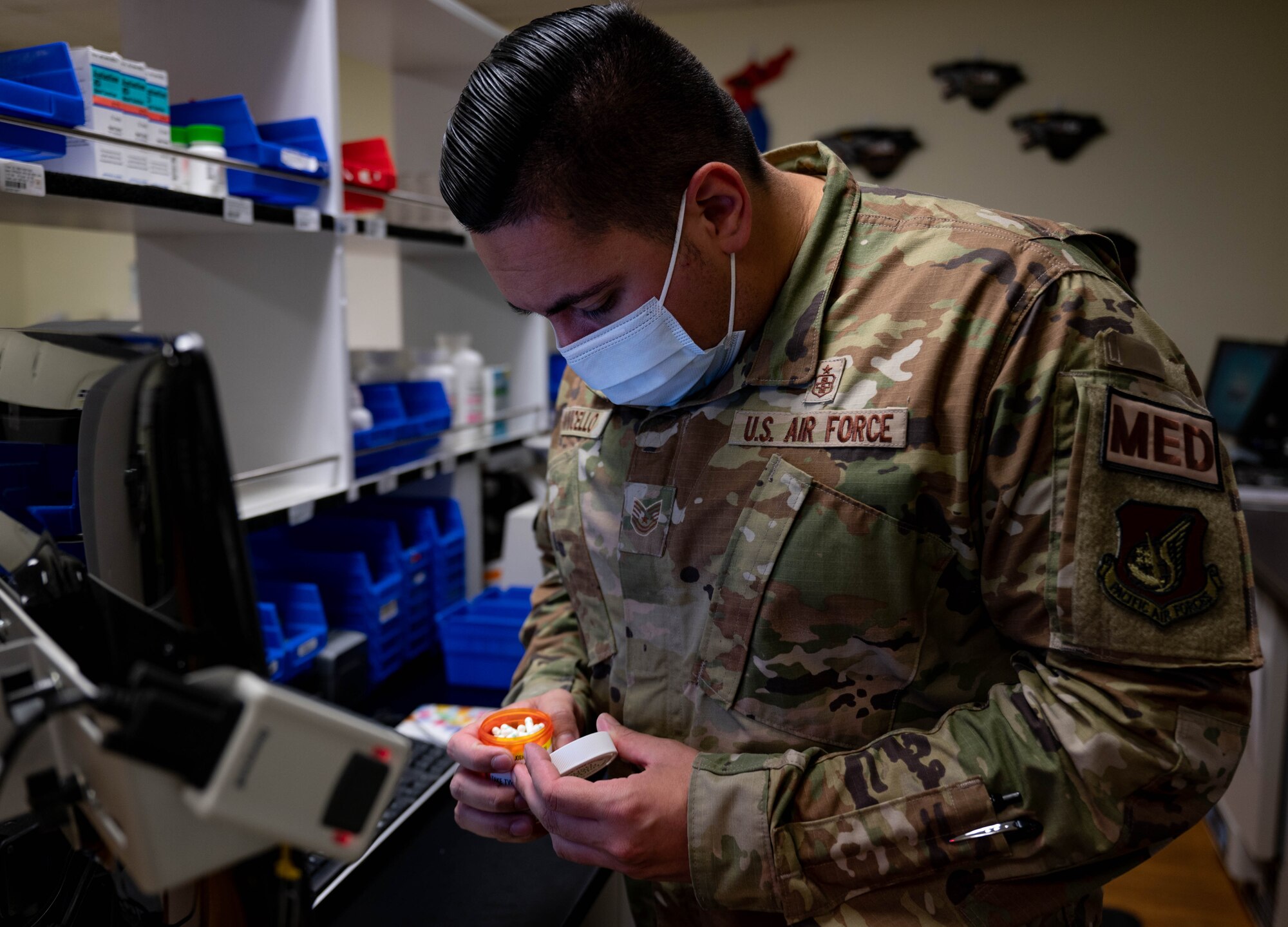 Tech. Sgt. Anthony Iannicello, 8th Healthcare Operations Squadron, pharmacy NCO in charge, verifies a bottle of medication, at Kunsan Air Base, Republic of Korea, Oct. 13, 2022. Before dispensing medication, pharmacy team members review the prescription orders to ensure the medication and dosage are correct. (U.S. Air Force Photo by Senior Airman Shannon Braaten)