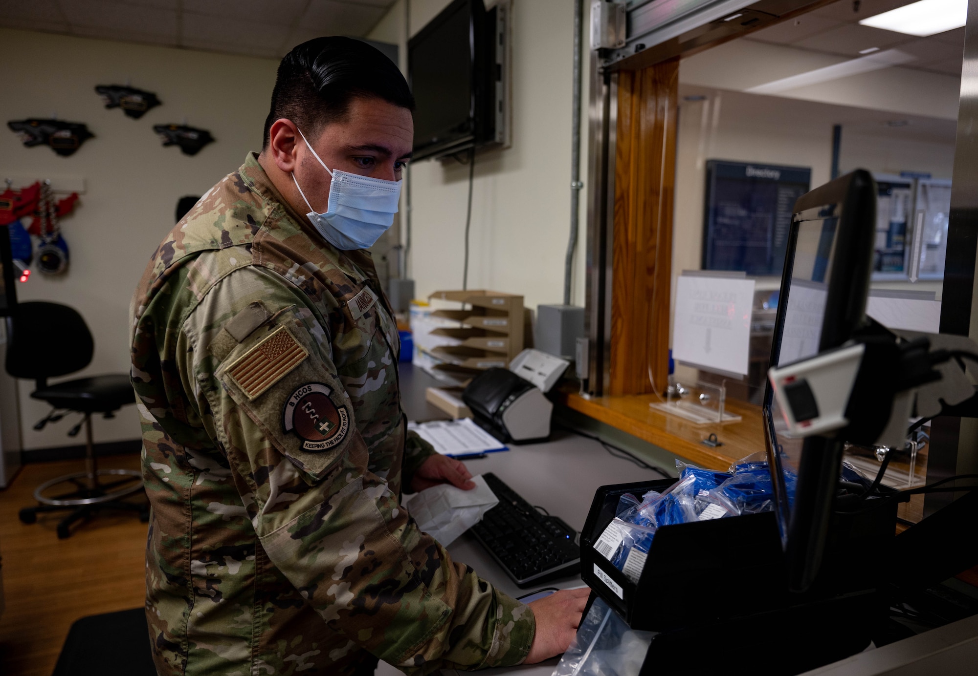 Tech. Sgt. Anthony Iannicello, 8th Health Care Operations Squadron, pharmacy NCO in charge, prepares to issue medication to a patient, at Kunsan Air Base, Republic of Korea, Oct. 13, 2022. Pharmacy team members address patient concerns and ensure all aspects of their prescription are understood before issuance. (U.S. Air Force Photo by Senior Airman Shannon Braaten)