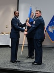 Col. Silas Darden, 960th Cyberspace Wing vice commander, presents the leadership guidon to Col. Richard Wallace, 960th COG commander, during the 960th COG change of command ceremony at Joint Base San Antonio-Lackland, Texas, Oct. 15, 2022. Wallace was the Individual Mobilization Augmentee to the 567th Cyberspace Operations Group commander at JBSA-Lackland. (U.S. Air Force photo by Staff Sgt. Monet Villacorte)