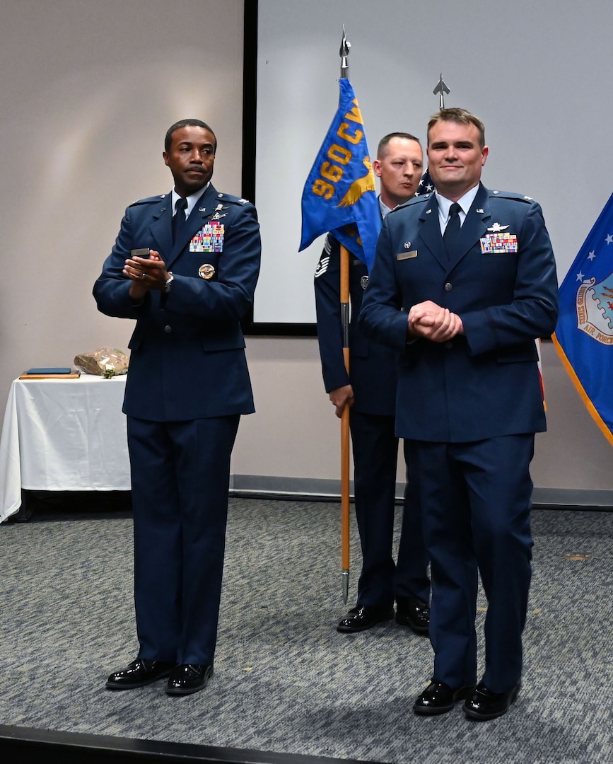 Col. Silas Darden, 960th Cyberspace Wing vice commander, claps after Col. Richard Wallace, 960th COG commander, accepts command during the 960th COG change of command ceremony at Joint Base San Antonio-Lackland, Texas, Oct. 15, 2022. As commander of the 960th COG, Wallace is responsible for the operations and staff activities of seven direct-reporting units and over 700 military and civilian personnel across four different states. (U.S. Air Force photo by Staff Sgt. Monet Villacorte)