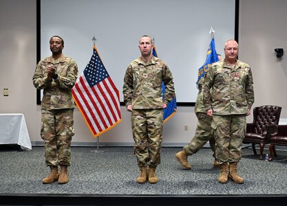 Col. Silas Darden, 960th Cyberspace Wing vice commander, Col. Joshua Garrison, 860th Cyberspace Operations Group commander, and Col. Thaddeus Janicki, 860th COG former commander, stand together during the 860th COG change of commander ceremony at Joint Base San Antonio-Lackland, Texas, Oct. 15, 2022. (U.S. Air Force photo by Staff Sgt. Monet Villacorte)