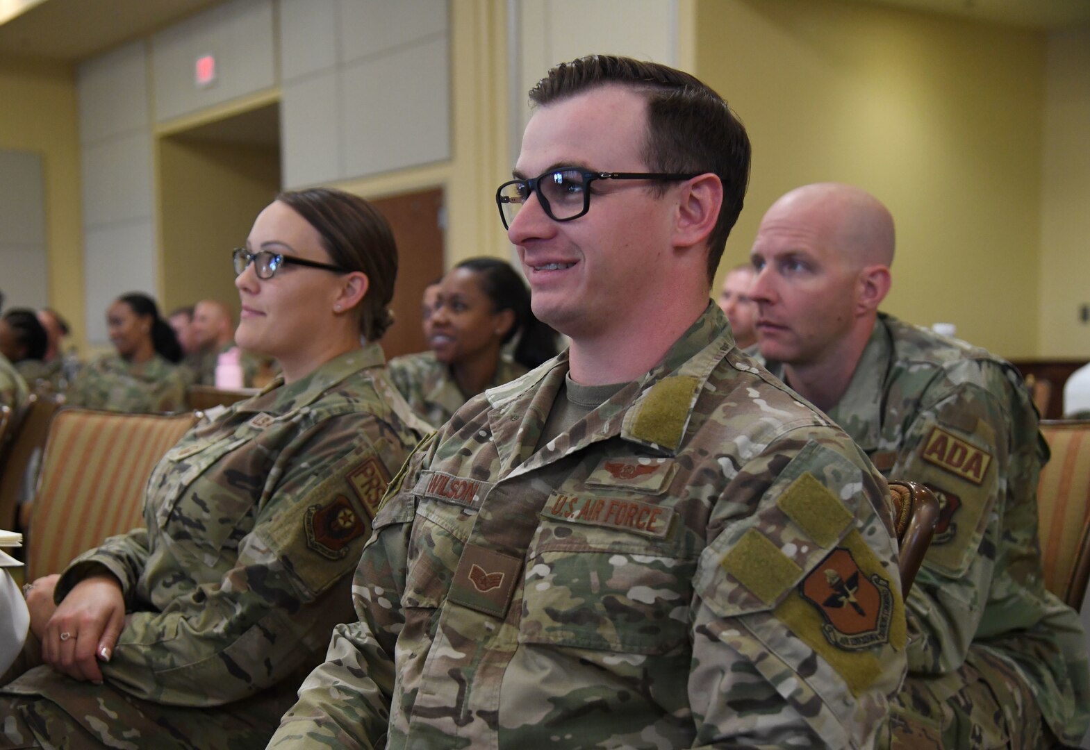 U.S. Air Force Master Sgt. Meghan Hoover, left, 193rd Special Operations Wing command support staff, and Staff Sgt. Dylan Wilson, right, 71st Special Operations Squadron special missions aviator, listen to a briefing during the inaugural Torch and Dagger professional development seminar at Keesler Air Force Base, Mississippi, October 14, 2022