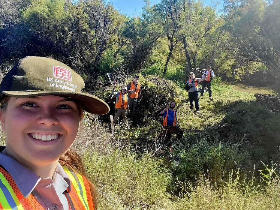 John Martin park ranger Holly Garnett and volunteers celebrate creating a path through tamarisk, an invasive species, to the Purgatoire River at the Black Bridge Recreation Area during the National Public Lands Day event there, Sept. 24, 2022.