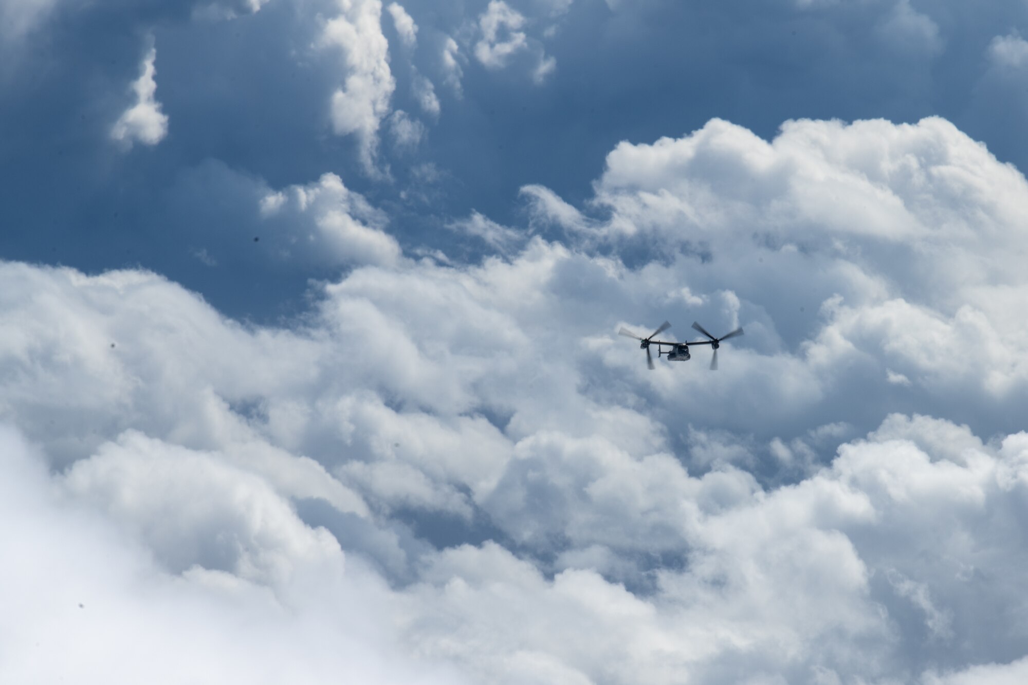 A CV-22 Osprey flies in clouds