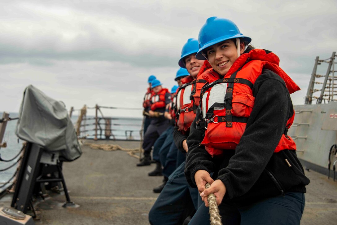 Legalman Seaman Audrey Carrillo, from Downey, Calif., heaves a line during a replenishment-at-sea with the Military Sealift Command fleet replenishment oiler USNS Henry J. Kaiser (T-AO 187) aboard the Arleigh Burke-class guided-missile destroyer USS Chung-Hoon (DDG 93).