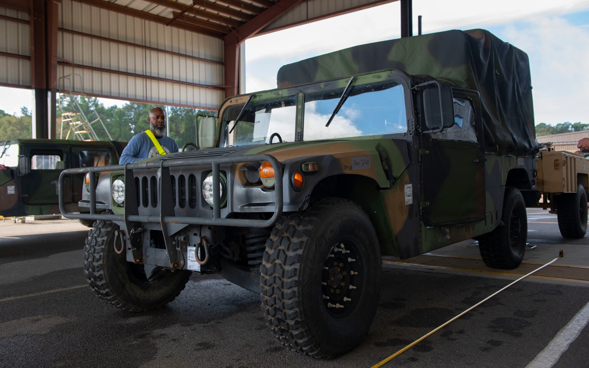 Air Force personal inspects a Humvee