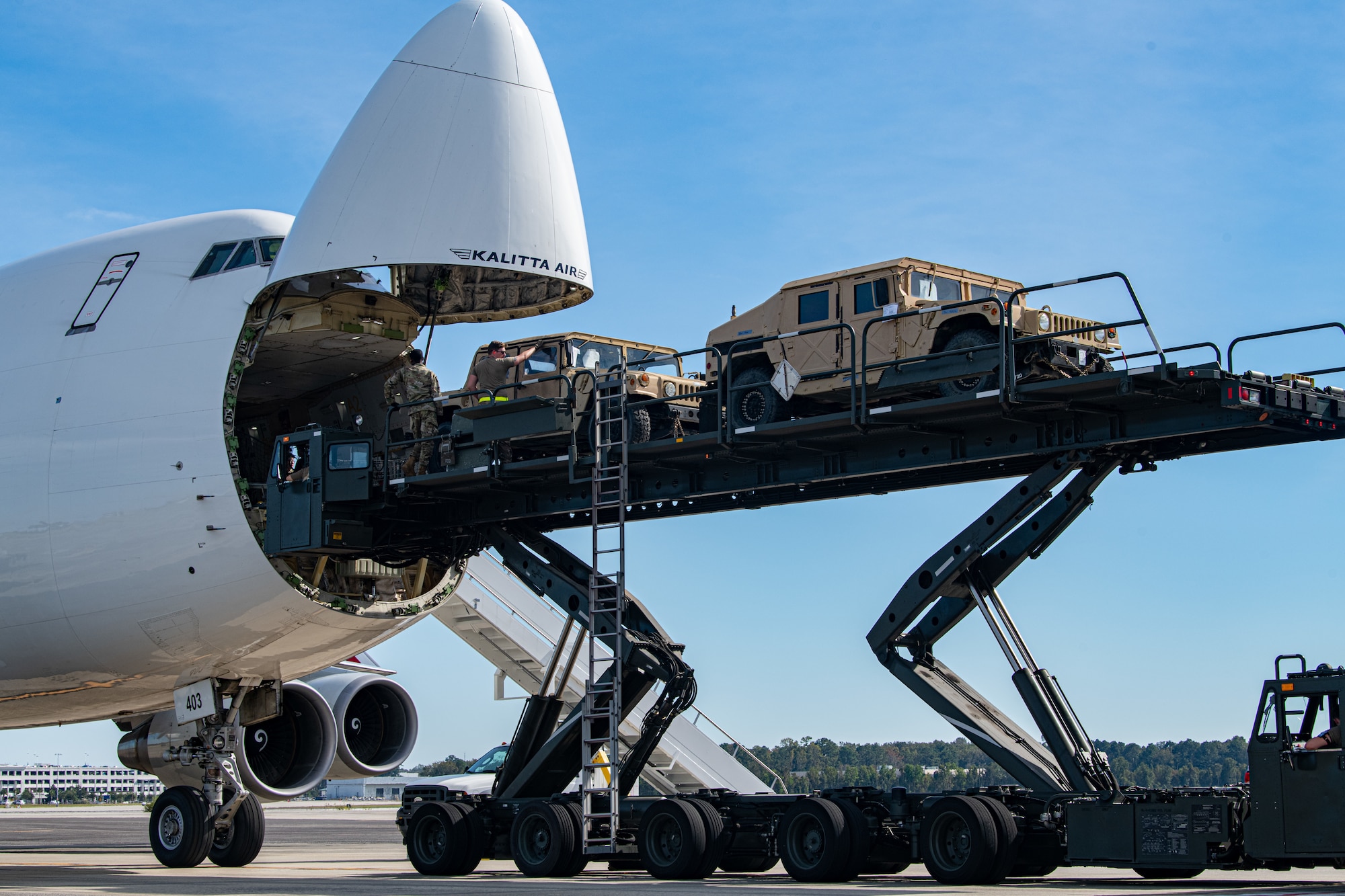 Trailers and Humvees are loaded on to a Boeing 747