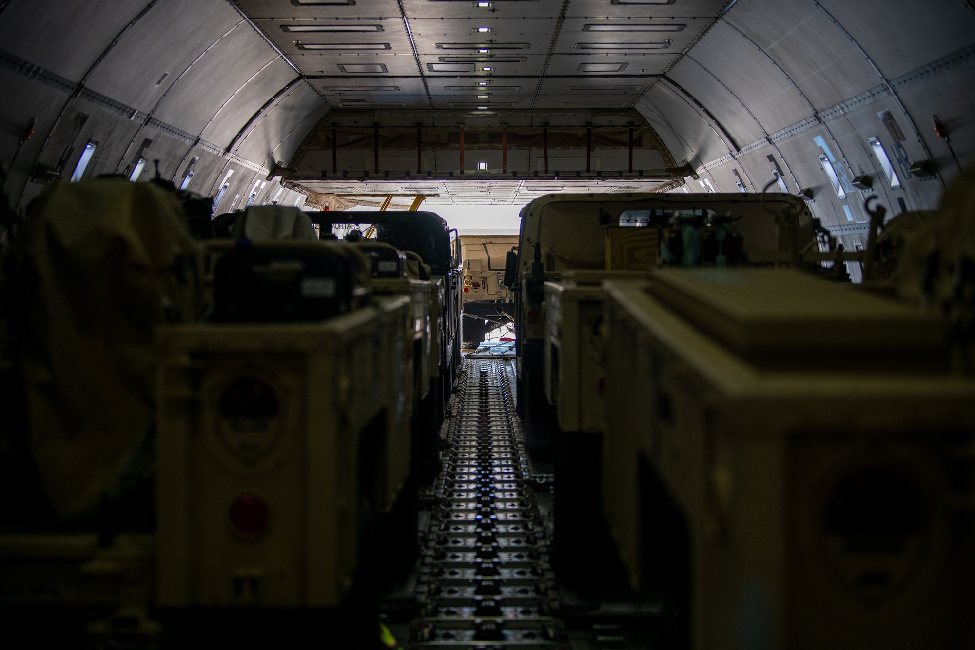 Trailers and Humvees sit in a Boeing 747
