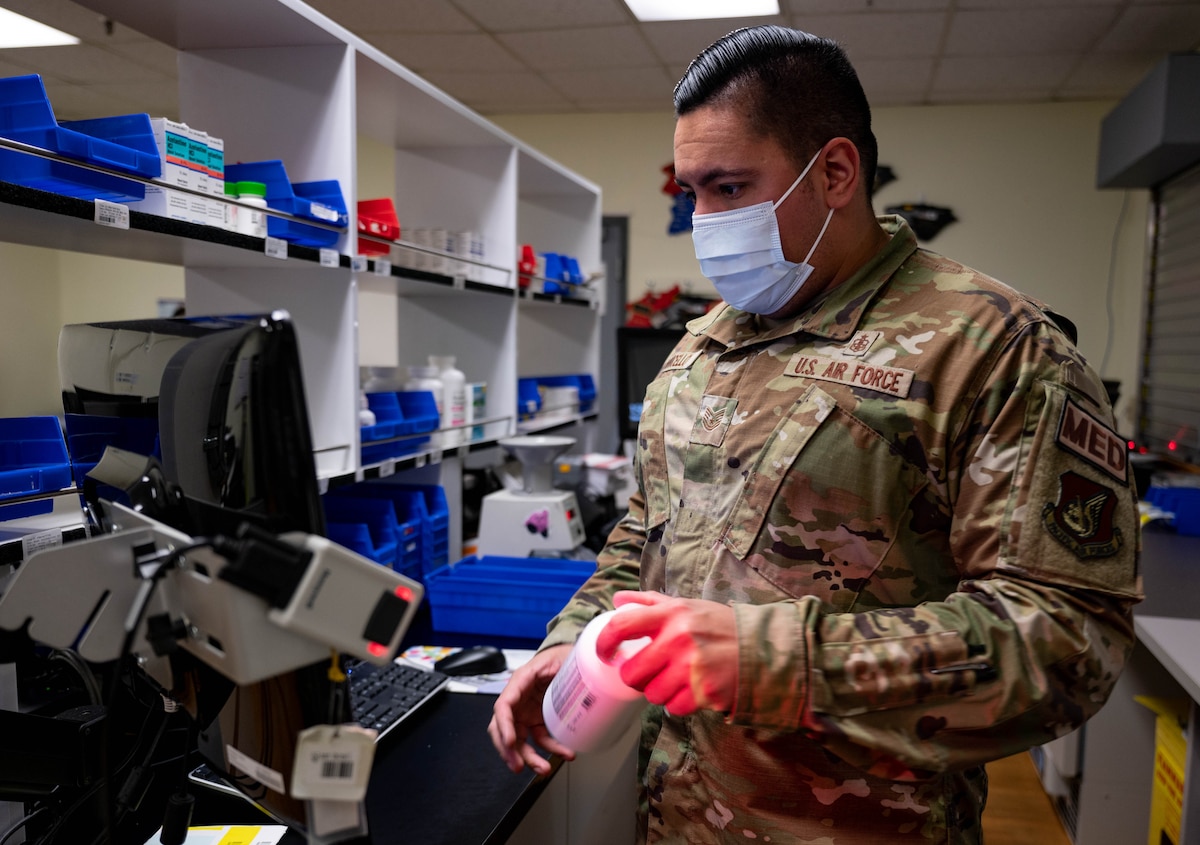 Image of an Airmen handling prescription medicine.