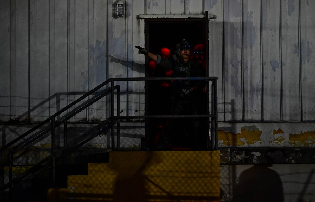 An operator participating in a combined U.S. and Republic of Korea (ROK) special operations forces training, calls out targets for others