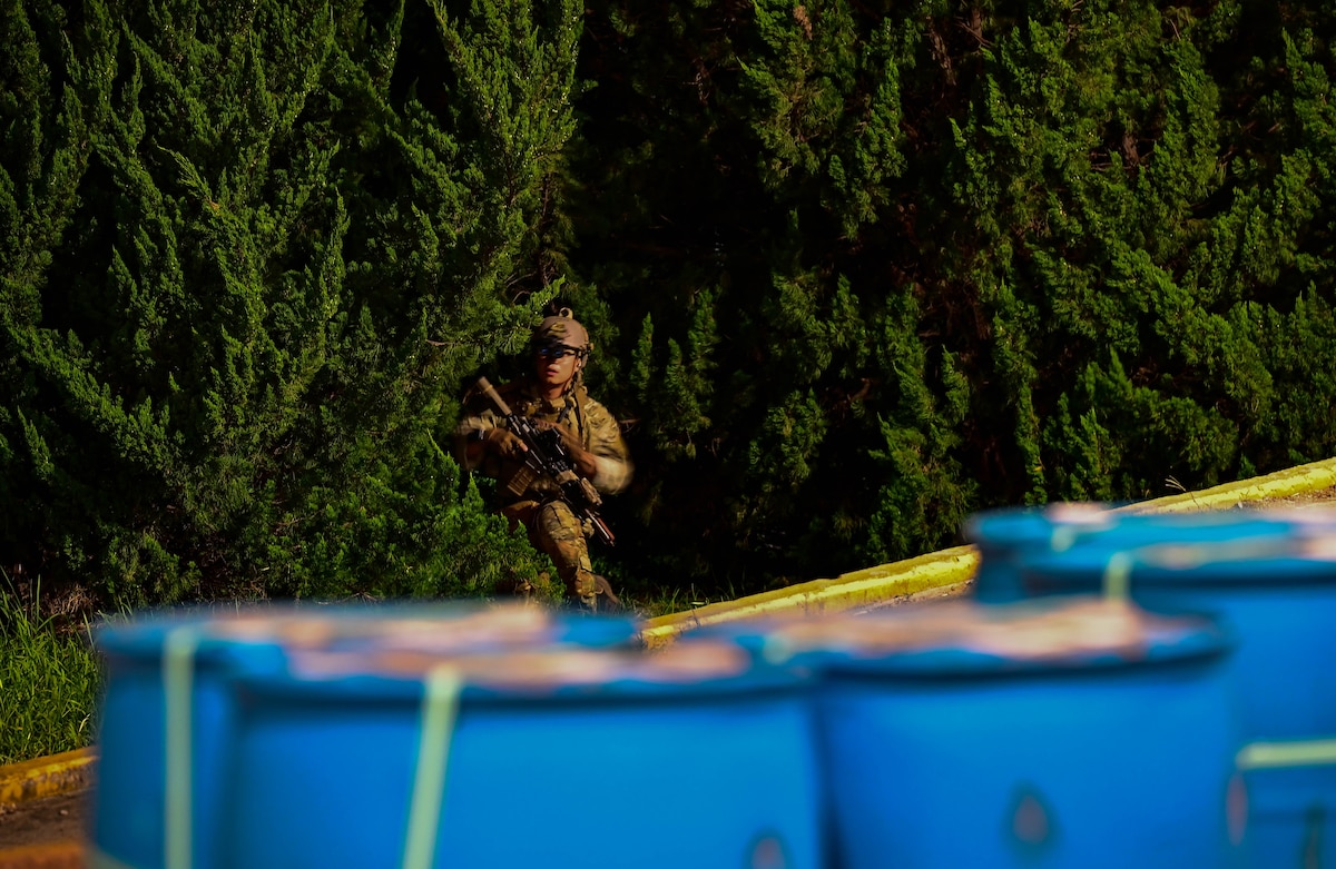 An operator participating in a combined U.S. and Republic of Korea (ROK) special operations forces training, sneaks through the tree line