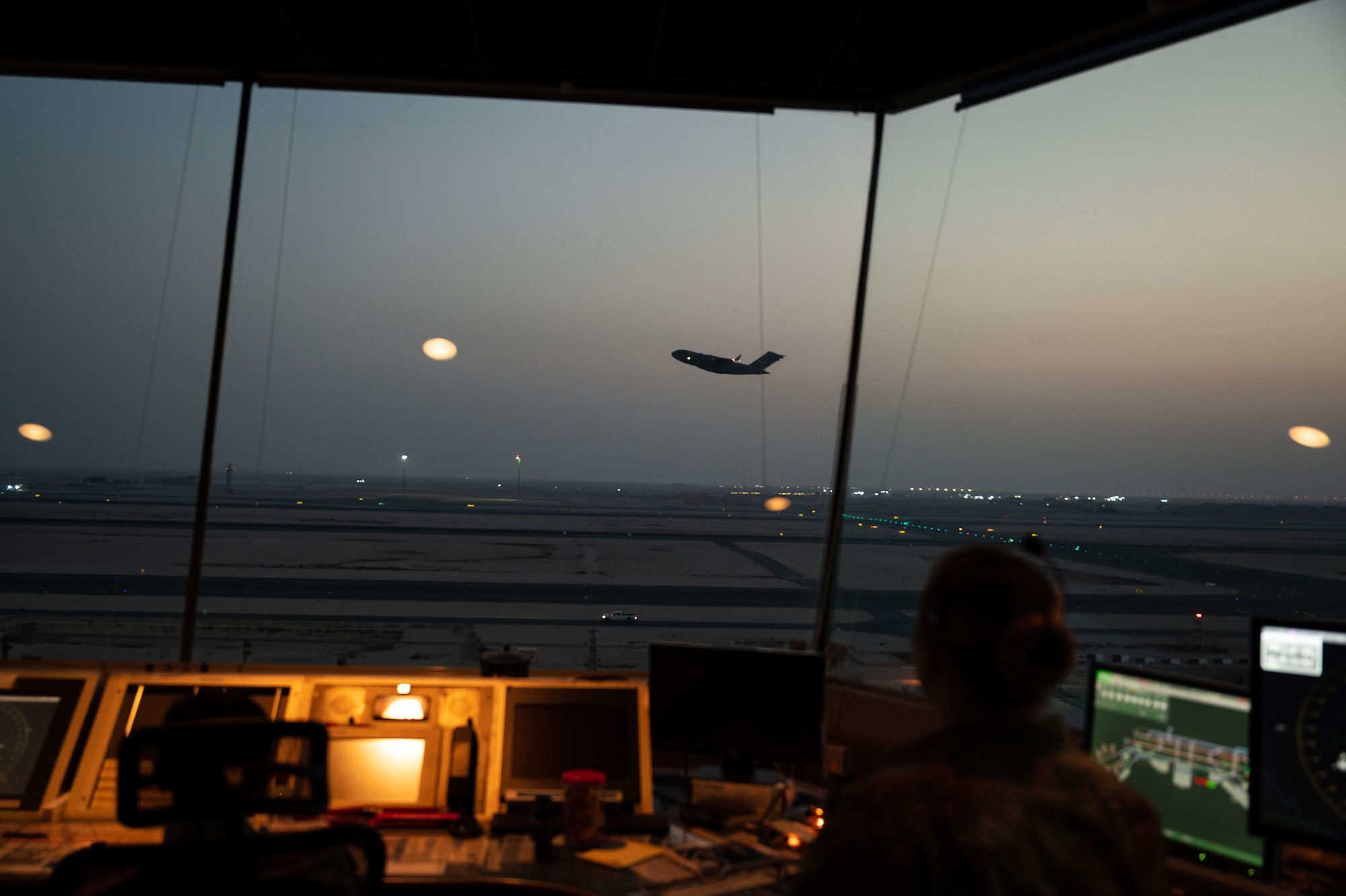 U.S. Air Force Tech Sgt. Ashley Stainbrook, air traffic watch supervisor, supervises the takeoff of a C-17 Globemaster III aircraft, Aug. 16, 2022 at Al Udeid Air Base, Qatar. Stainbrook oversees all operations in the control tower and helps foster a positive relationship with partner air traffic controllers in the Qatar Emiri Air Force. (U.S. Air Force photo by Staff Sgt. Dana Tourtellotte)