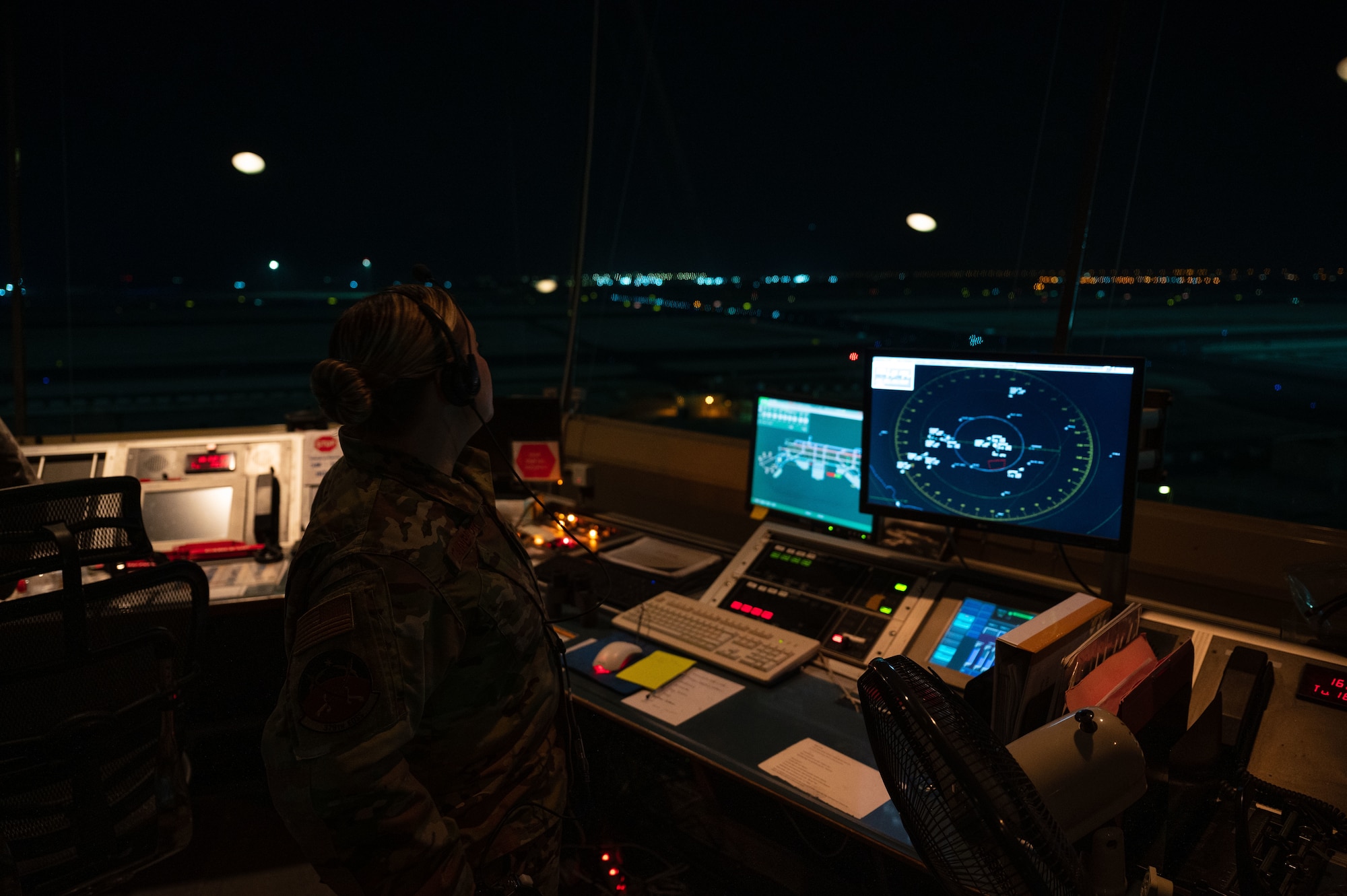 U.S. Air Force Tech Sgt. Ashley Stainbrook, air traffic watch supervisor, surveys the radar screen and skies around the control tower, Aug 16, 2022 at Al Udeid Air Base, Qatar. Stainbrook oversees all operations in the control tower and helps foster a positive relationship with partner air traffic controllers in the Qatar Emiri Air Force. (U.S. Air Force photo by Staff Sgt. Dana Tourtellotte)