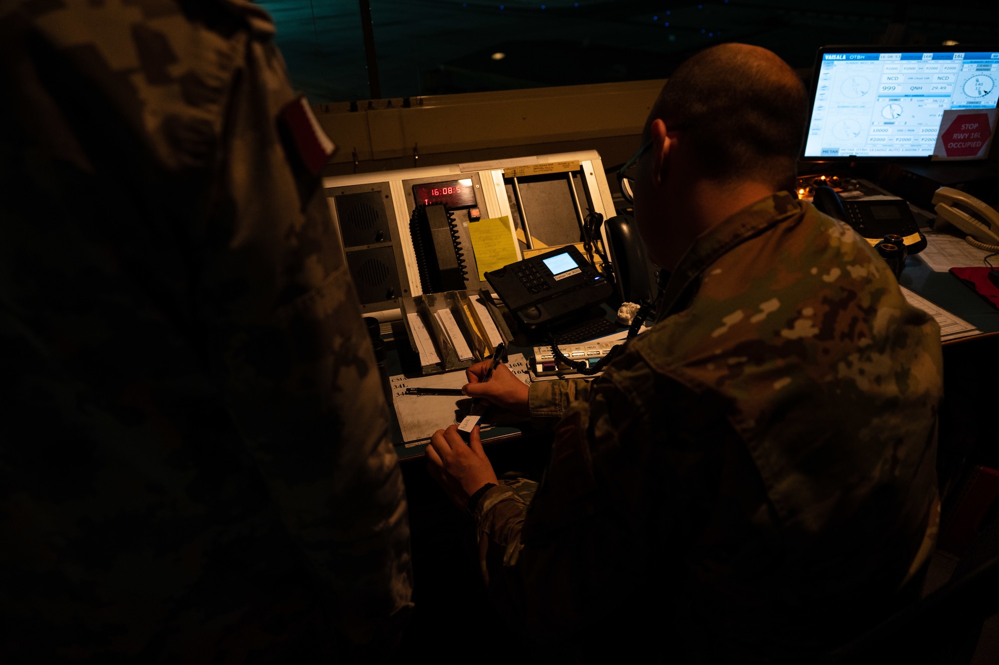 U.S. Air Force Senior Airman Evan Lackey, an air traffic controller, creates an aircraft arrival strip Aug. 16, 2022 at Al Udeid Air Base, Qatar. Lackey works in the control tower side by side with partner air traffic controllers from the Qatar Emiri Air Force. (U.S. Air Force photo by Staff Sgt. Dana Tourtellotte)