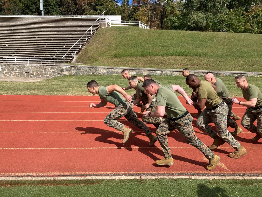 Marines from across Headquarters Battalion conduct the Movement to Contact portion of their Combat Fitness Test aboard Marine Corps Base Quantico.