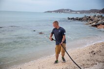 U.S. Marine Cpl. Brandon Fenley, a water support technician with Joint Task Force - Leeward Islands, drags the hose for a Lightweight Water Purification System into the ocean at a water distribution site in Saint Martin, Sept. 14, 2017. The system allows the Marines to purify approximately 1,800 gallons of water a day in order to supply communities on the island affected by Hurricane Irma. At the request of partner nations, JTF-LI deployed aircraft and service members to areas in the eastern Caribbean Sea affected by Hurricane Irma. The task force is a U.S. military unit composed of Marines, Soldiers, Sailors, and Airmen, and represents U.S. Southern Command’s primary response to Hurricane Irma. (U.S. Marine Corps photo by Sgt. Ian Leones)