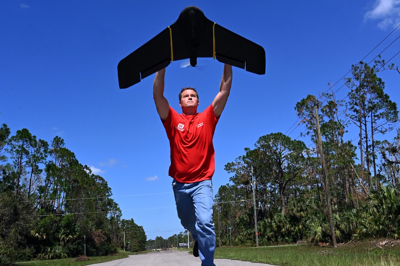 A man launches a drone.