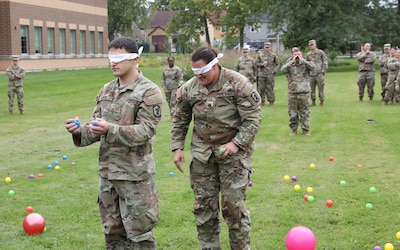 Staff Sgt. Brittany Klein and Pvt. 1st Class Connor Rijkse of the 933rd Military Police Company participate in a trust-building activity during Discrimination Prevention training at the North Central Army Reserve Intelligence Support Center, Fort Sheridan, Illinois, September 24, 2022.