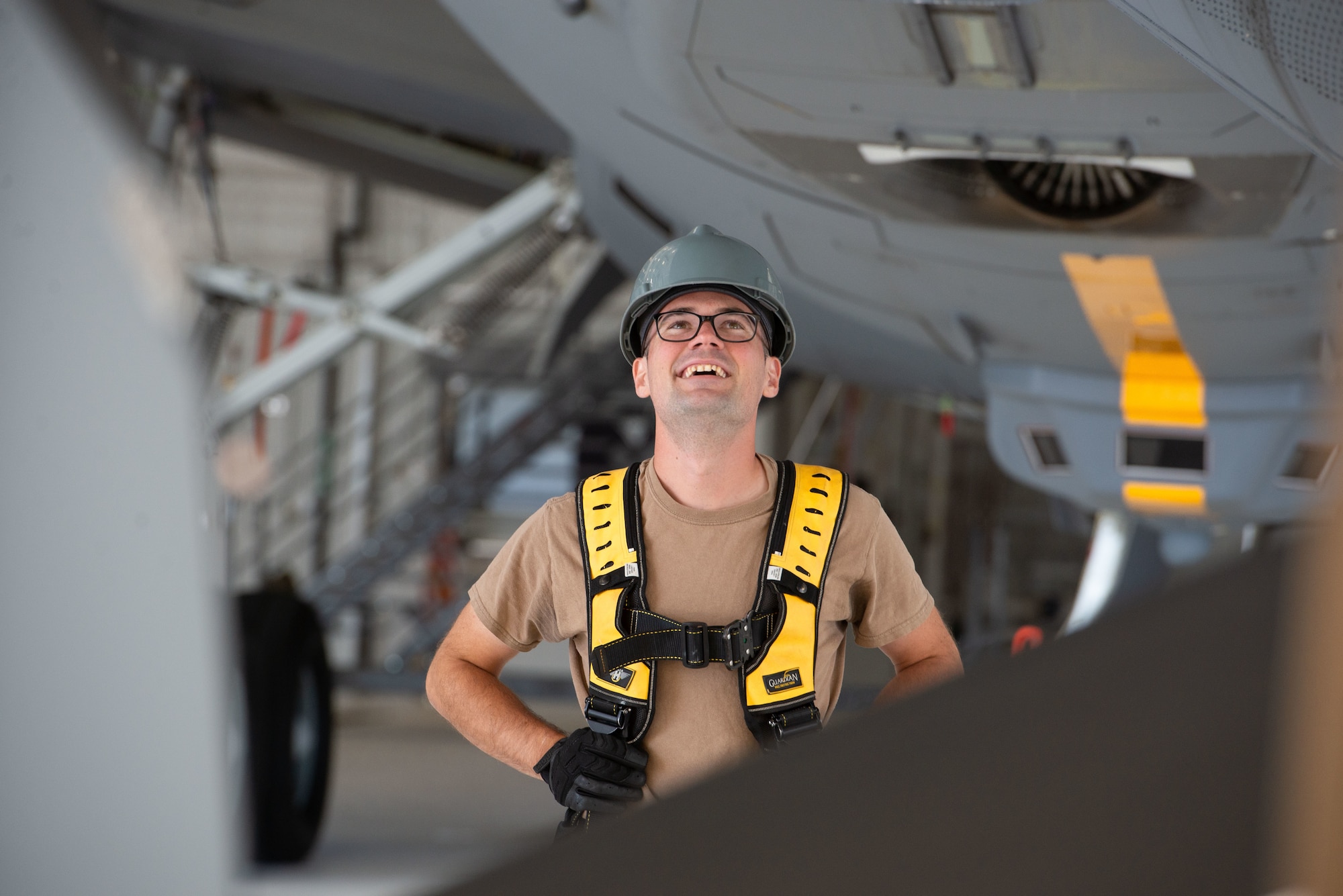 Staff Sgt. Alexander Desmarais, an engine mechanic with the 157th Maintenance Group, watches a suspended auxiliary power unit lift into a KC-46 Sept. 28, 2022 at Pease Air National Guard Base, New Hampshire.