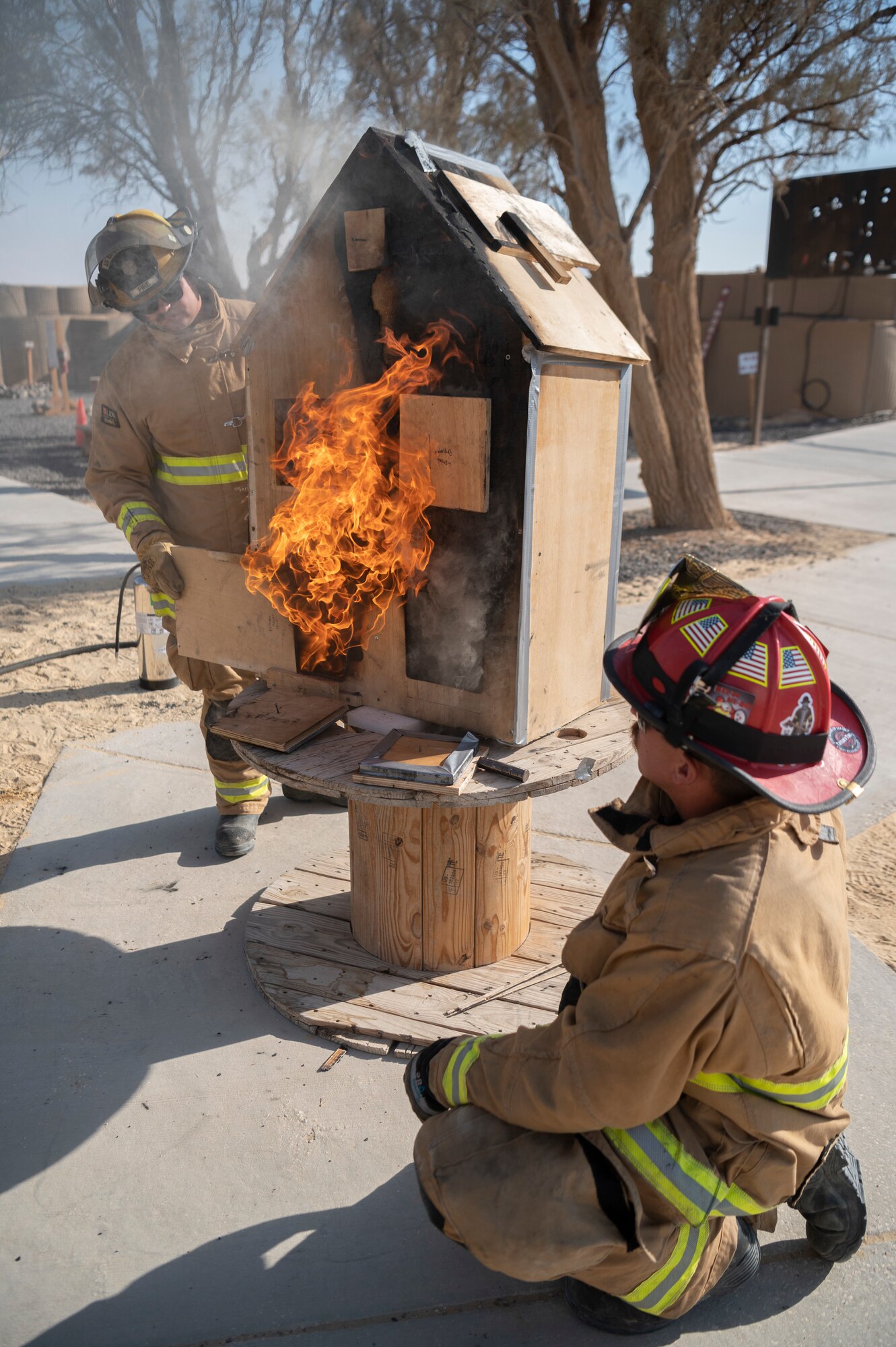 The 332d Expeditionary Civil Engineer Squadron Fire and Emergency Services conduct flow and ventilation demonstrations during Fire Prevention Week at an undisclosed location in Southwest Asia, October 9-15, 2022. The 332d ECES taught fire prevention, performed an aircraft egress demonstration, conducted structure burns, flow and ventilation demonstrations, and a fire muster fitness competition. (U.S. Air Force photo by Tech. Sgt. Jeffery Foster)