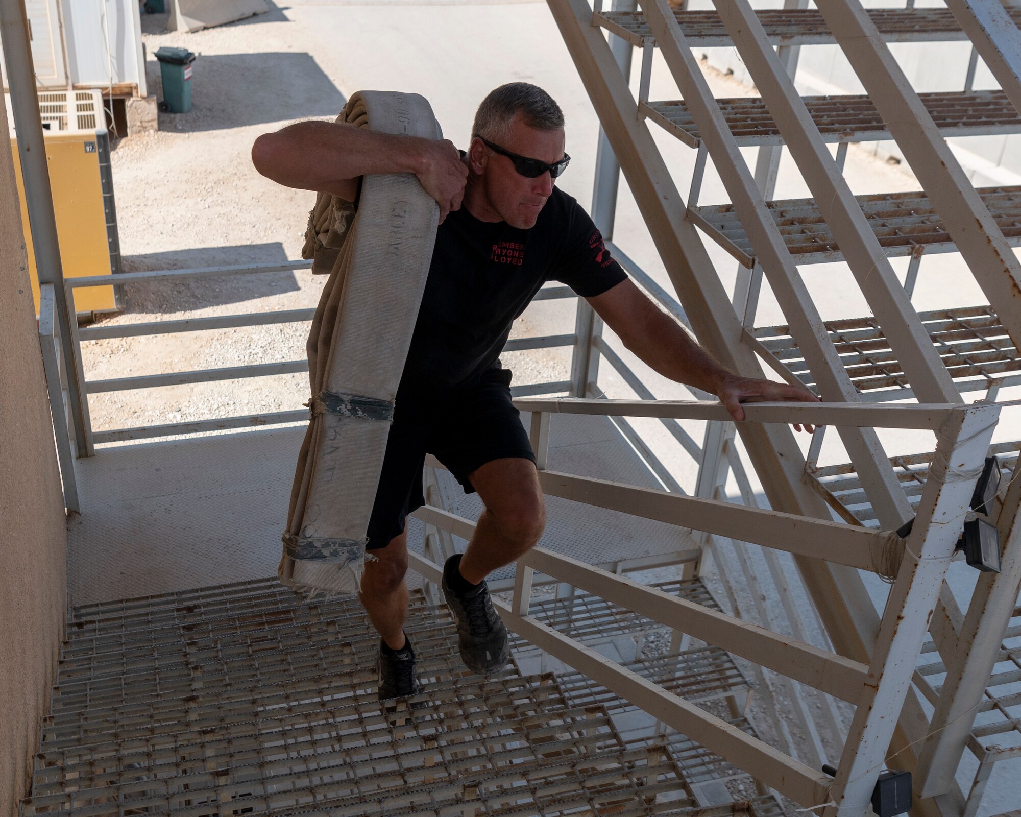 U.S. Air Force Senior Master Sergeant Sean Emenhizer, 332d Expeditionary Civil Engineer Squadron, Chief Executive Officer, participates in the 332d Air Expeditionary Wing Fire Muster at an undisclosed location in Southwest Asia, October 15, 2022. The 332d ECES taught fire prevention, performed an aircraft egress demonstration, conducted structure burns, flow and ventilation demonstrations, and a fire muster fitness competition. (U.S. Air Force photo by Tech. Sgt. Jeffery Foster)