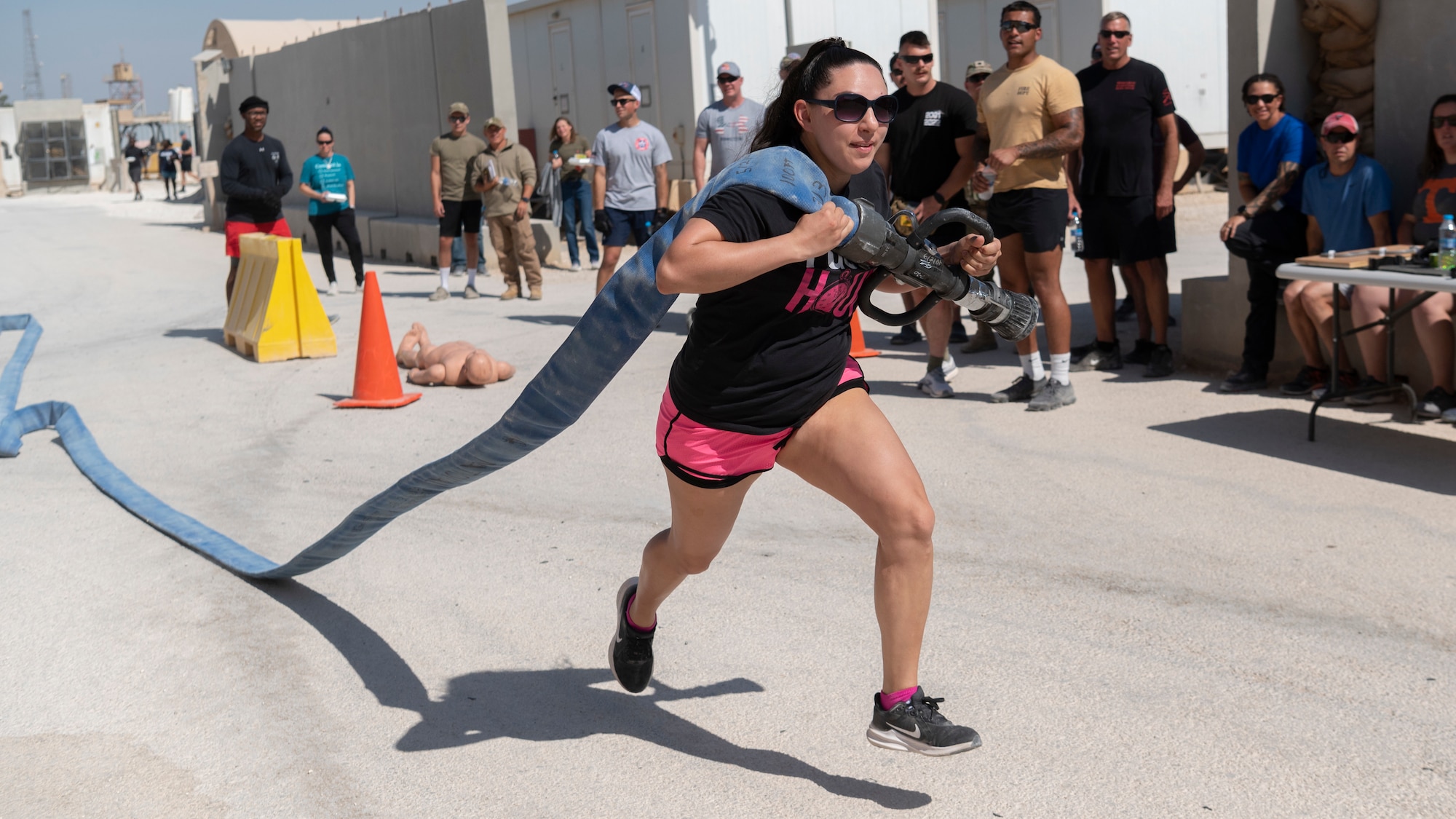 U.S. Air Force Staff Sergeant Alexandra Ayub, Non-Appriated Funds Accountant, 332d Expeditionary Force Support Squadron, participates in the 332d Air Expeditionary Wing Fire Muster at an undisclosed location in Southwest Asia, October 15, 2022. The 332d ECES taught classes on fire prevention, performed an aircraft egress demonstration, conducted structure burns, flow and ventilation demonstrations, and a fire muster fitness competition. (U.S. Air Force photo by Tech. Sgt. Jeffery Foster)