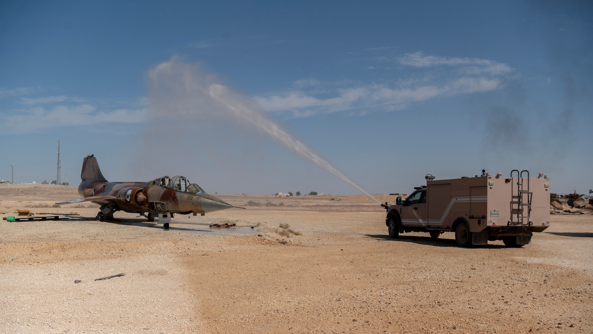 An Airport Rescue Firefighting vehicle demonstrates its capabilities during Fire Prevention Week at an undisclosed location in Southwest Asia, October 12, 2022. During Fire Prevention Week, the 332d Expeditionary Civil Engineer Squadron taught fire prevention, performed an aircraft egress demonstration, conducted structure burns, flow and ventilation demonstrations, and a fire muster fitness competition. (U.S. Air Force photo by Tech. Sgt. Jeffery Foster)