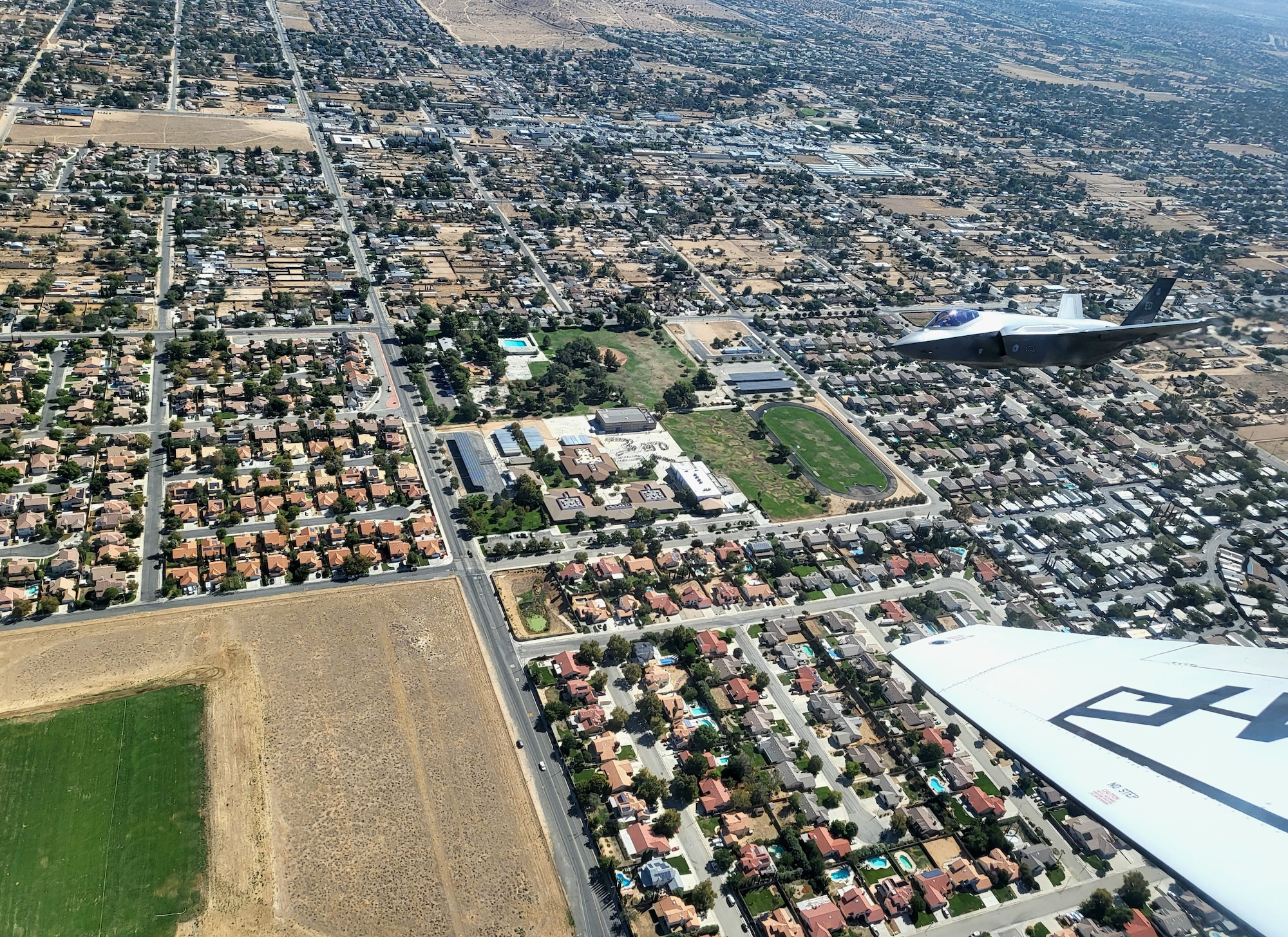 An F-35 flies over Joe Walker Middle School during the
Aerospace Valley Science, Technology, Engineering, and Mathematics (STEM) outreach flyover Oct. 12. The flyover route reached the California communities of Edwards, Boron, Helendale, Victorville, Hesperia, El Mirage, Lake Los Angeles, Palmdale, Quartz Hill, Lancaster, Rosamond, Tehachapi, Mojave and California City with dedicated points at schools ranging from kindergarten to college. (U.S. Air Force photo by Jessica Peterson)