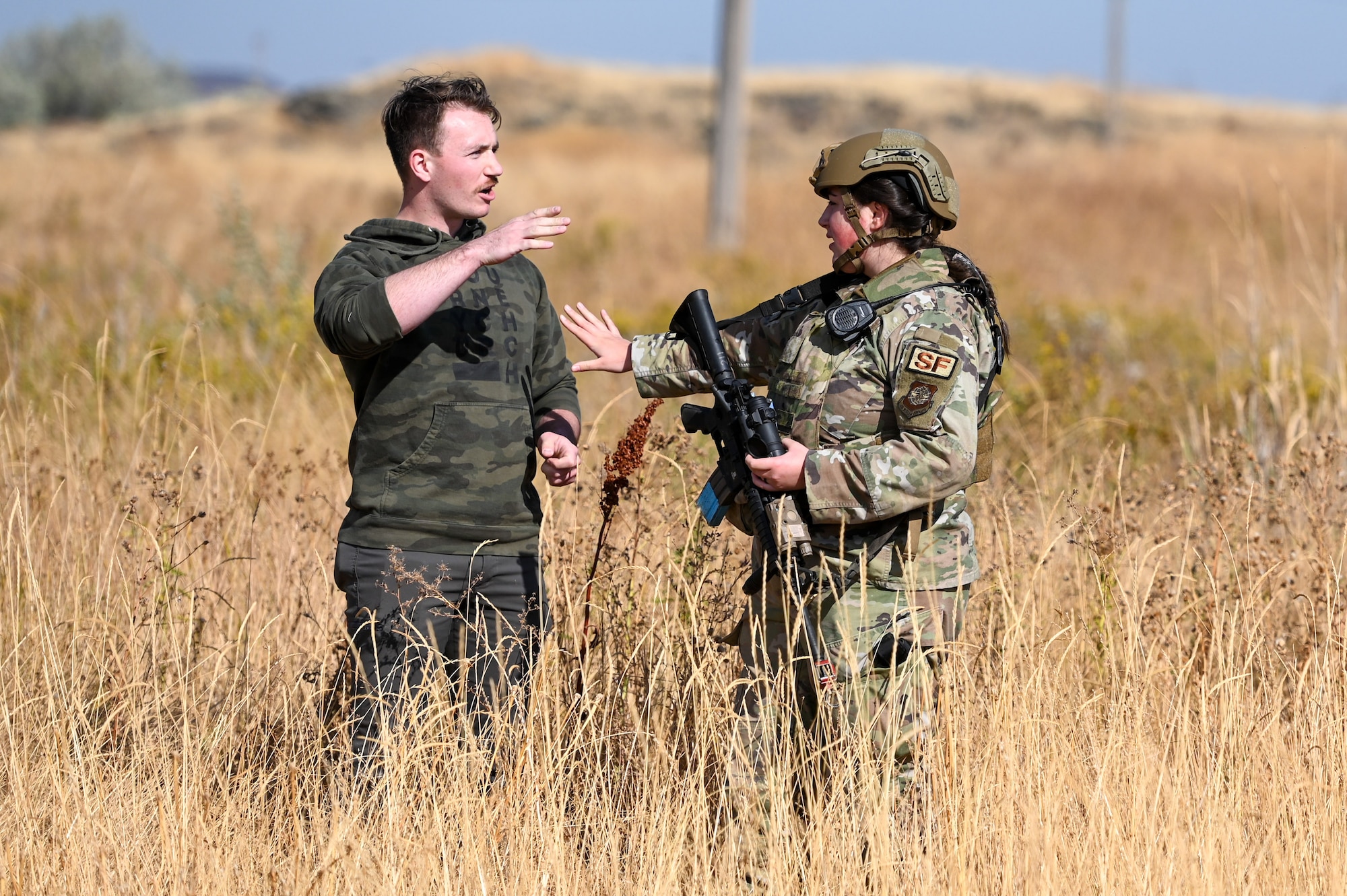 An Airmen from the 92nd Security Forces Squadron prevents a participant attempting to gain access to the base during a Combat Readiness Training (CRT) exercise at Fairchild Air Force Base, Washington, September 27, 2022. CRT is locally designed program conducted once a year on a large scale that reteaches the basics to Security Forces Airmen. (U.S. Air Force photo by Airman 1st Class Morgan Dailey)
