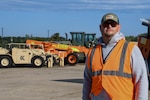 Robert Montgomery stands outside wearing an orange safety vest.